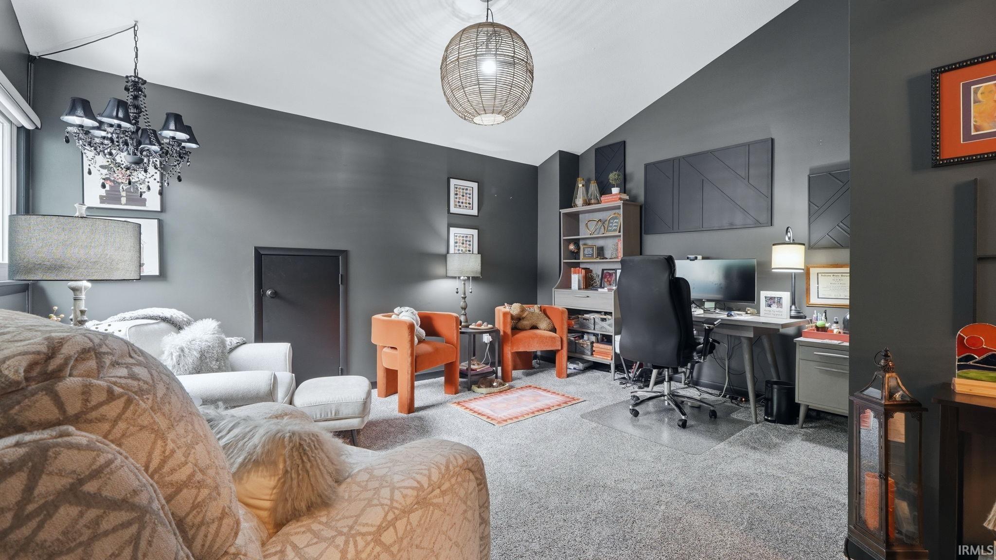 Spacious room with vaulted ceilings and gray carpeting