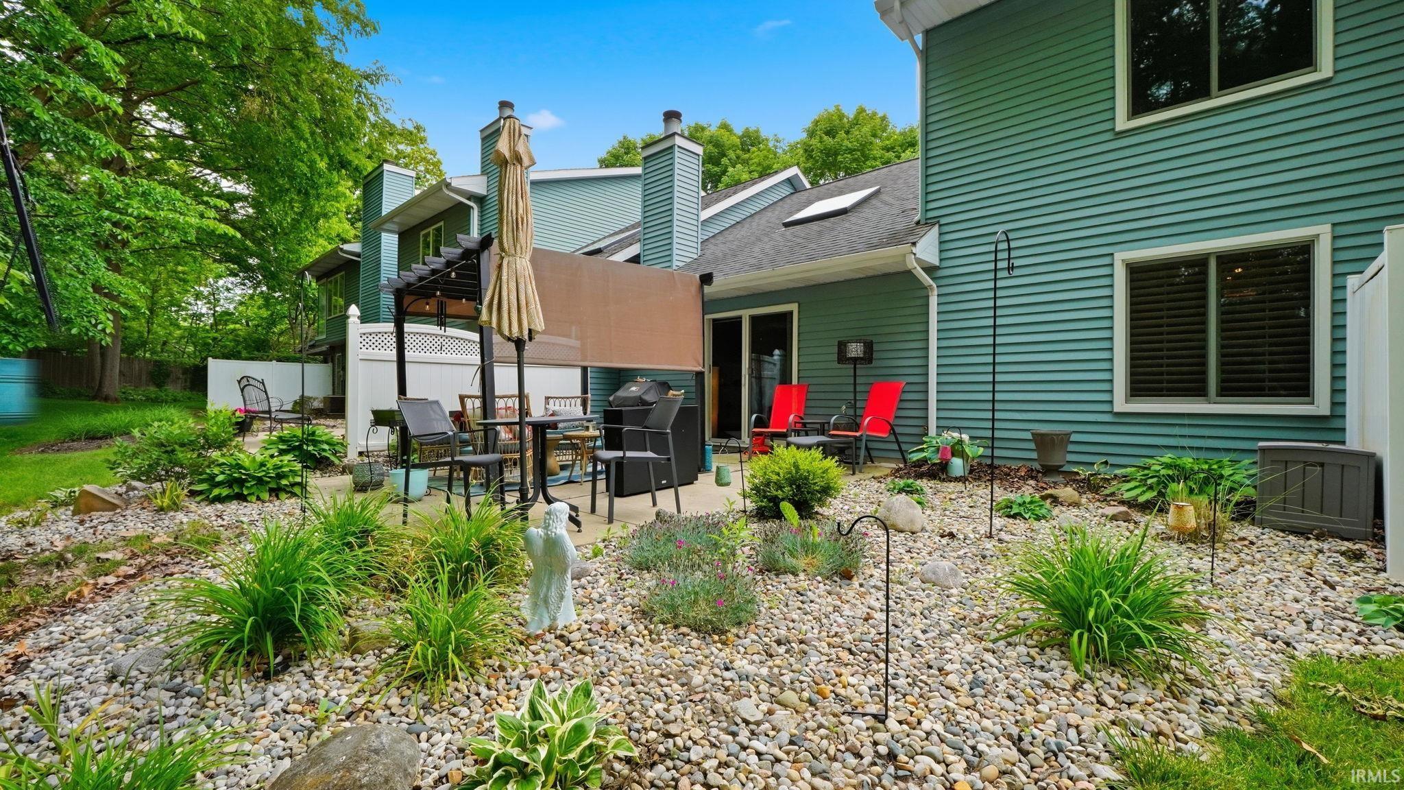 Outdoor patio area featuring a pergola structure and privacy screening