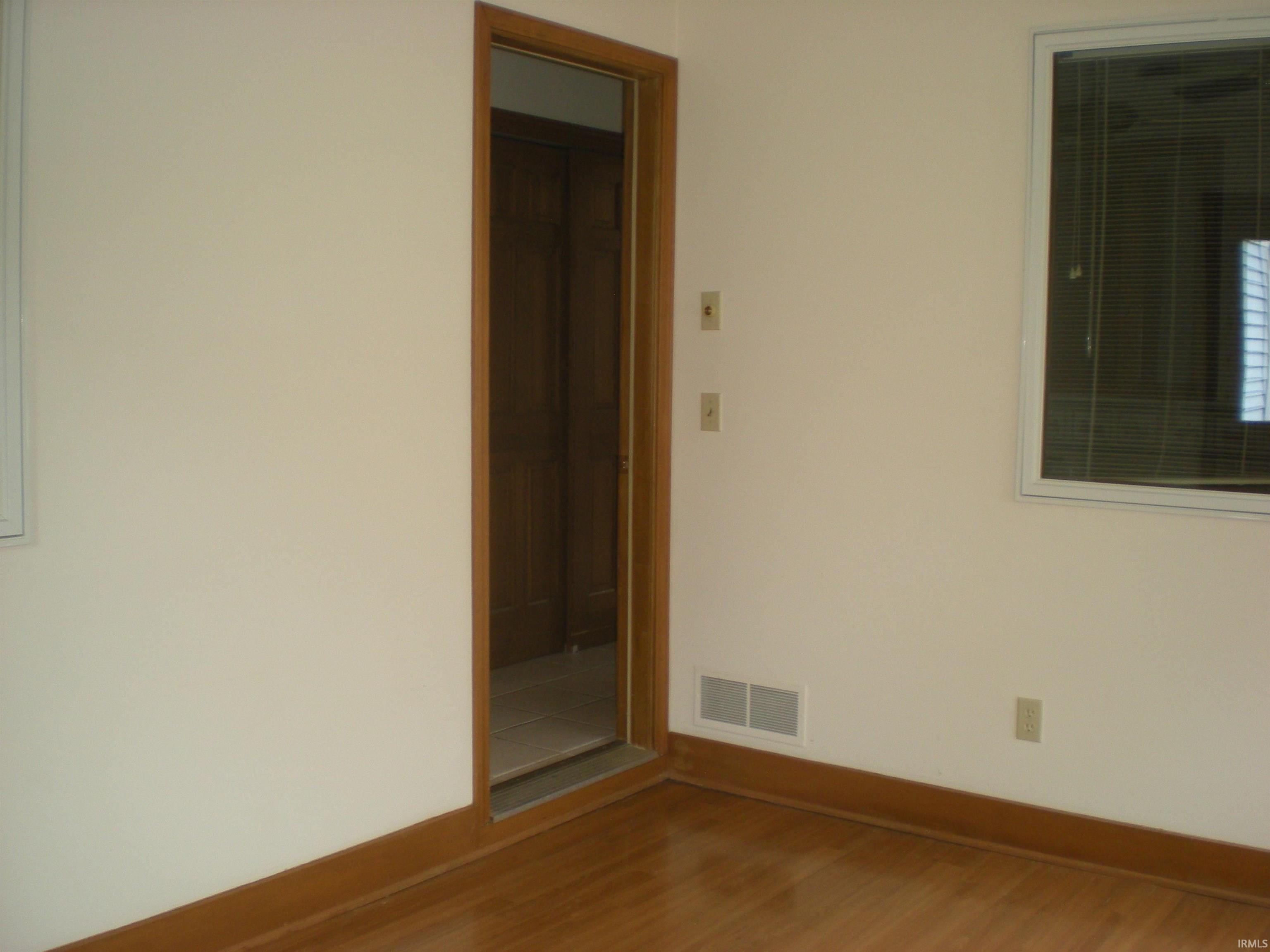 Interior space featuring wood-finish flooring and light-toned walls