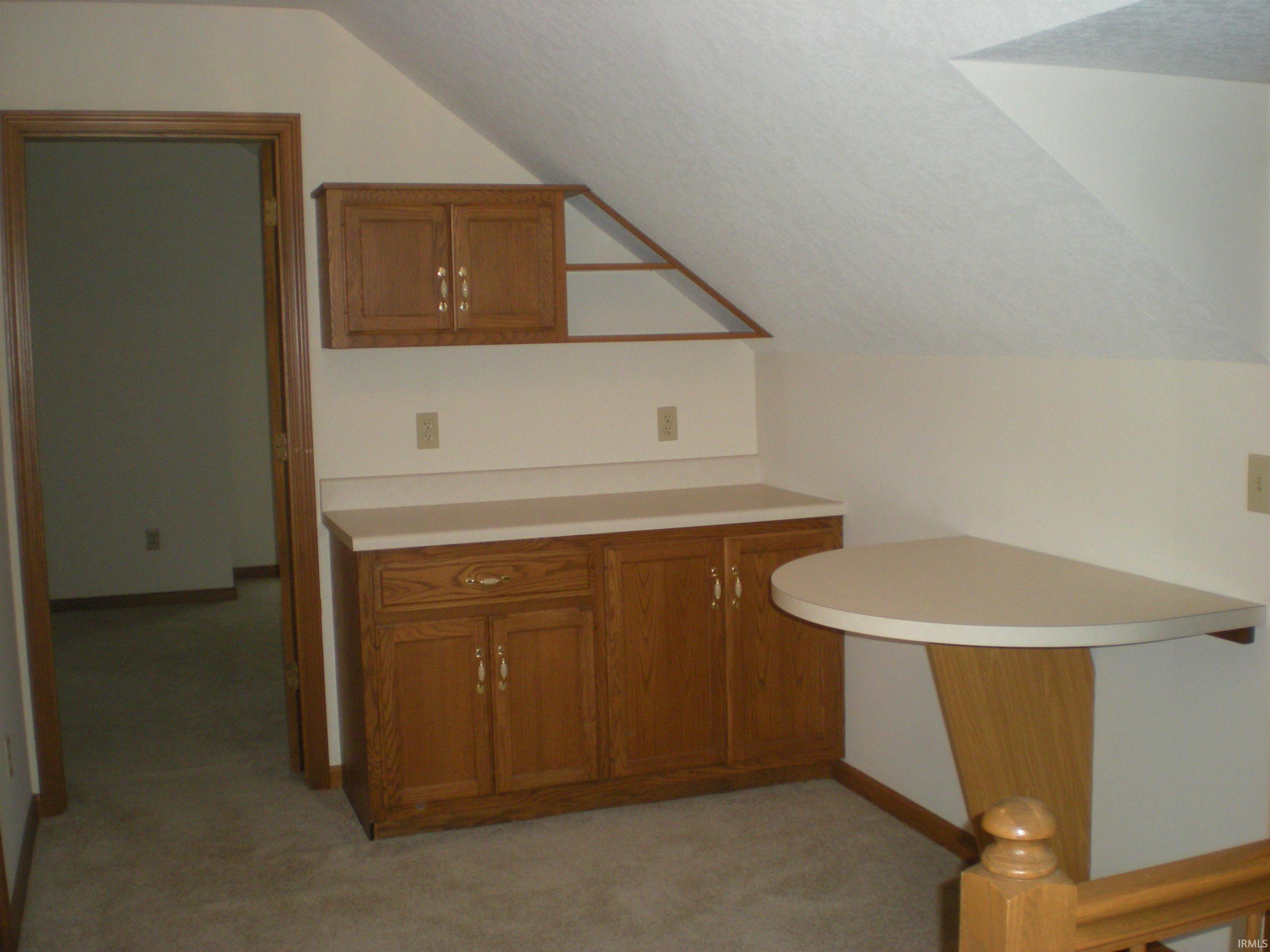 Built-in cabinetry with wood-finish doors and light-toned countertops