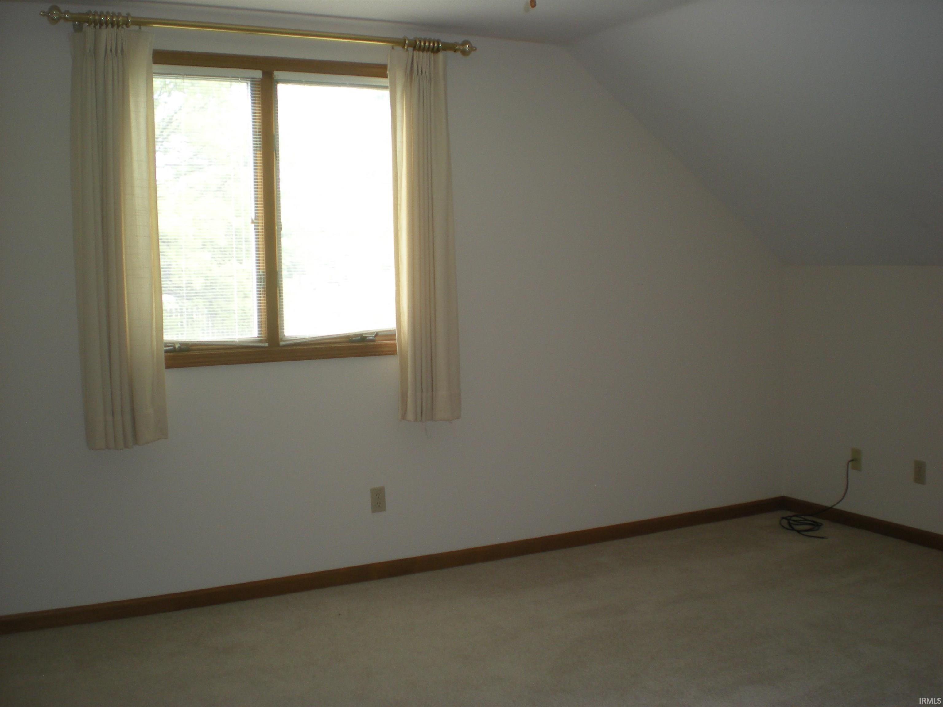 Room featuring light-toned carpeting and white walls