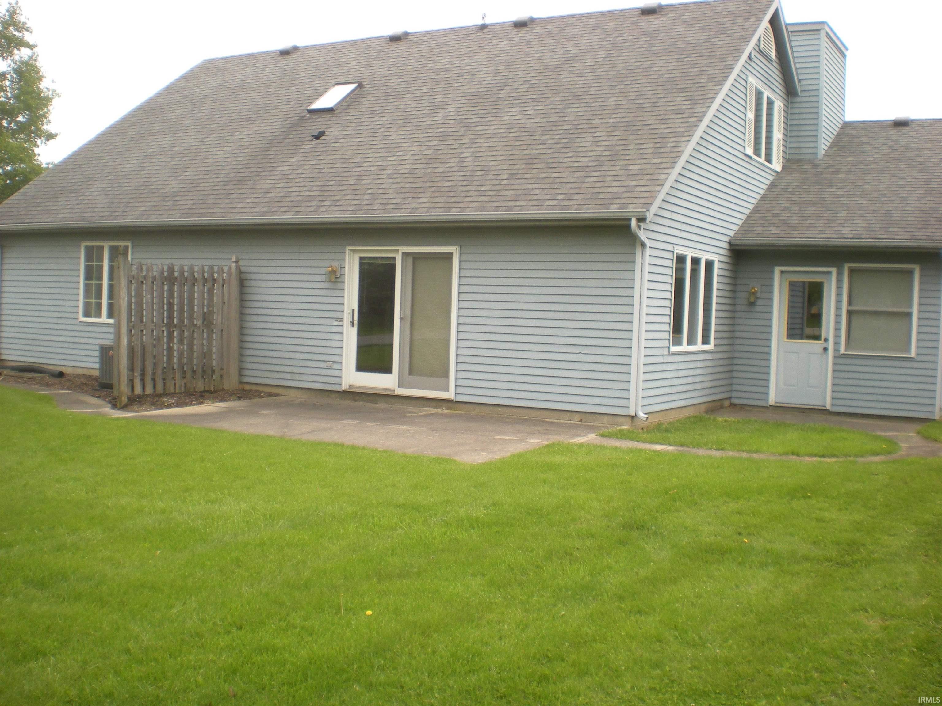 Exterior featuring light blue siding, a shingle roof, and multiple windows