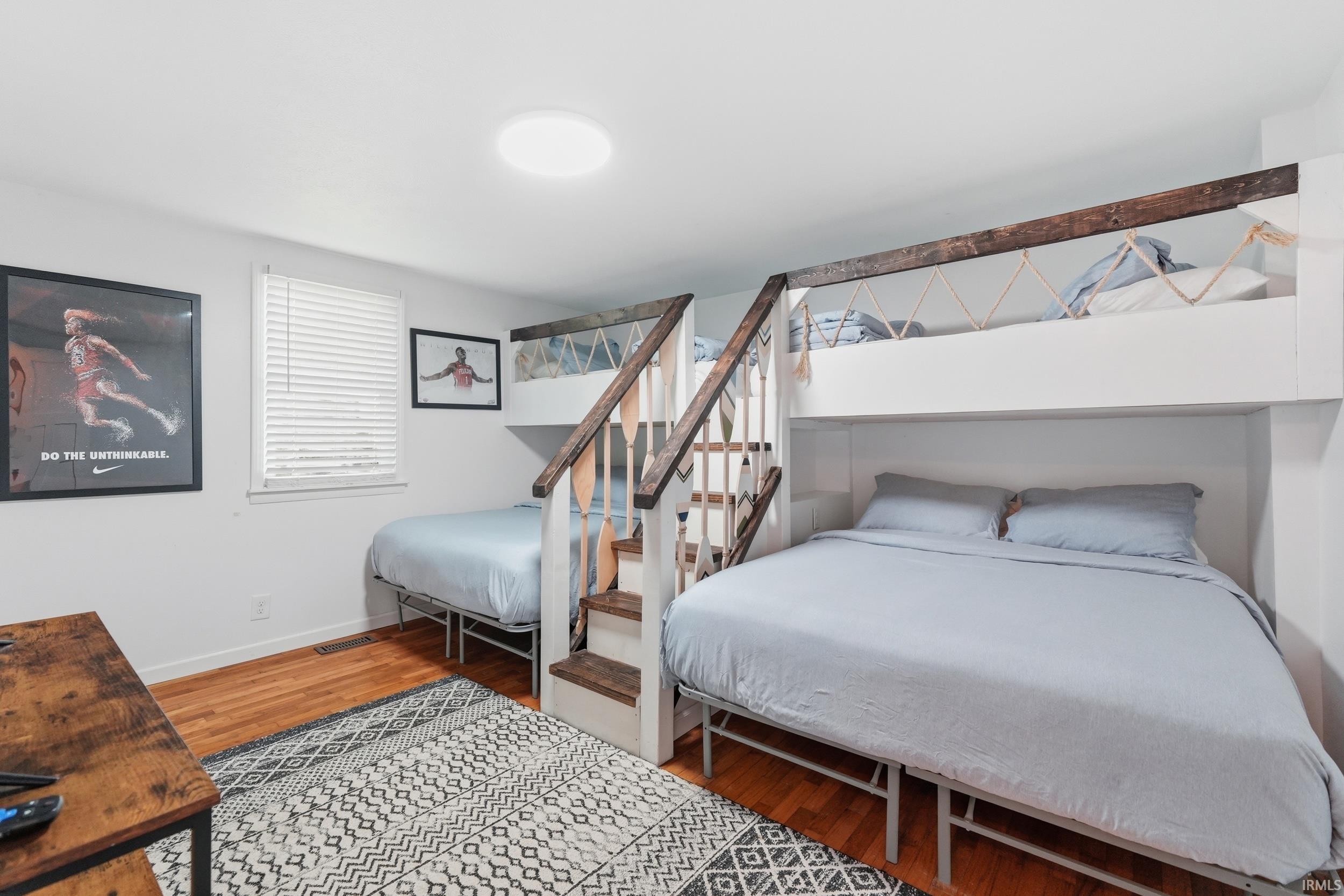 Custom built-in bunk beds with integrated stairs and wood-finish railings