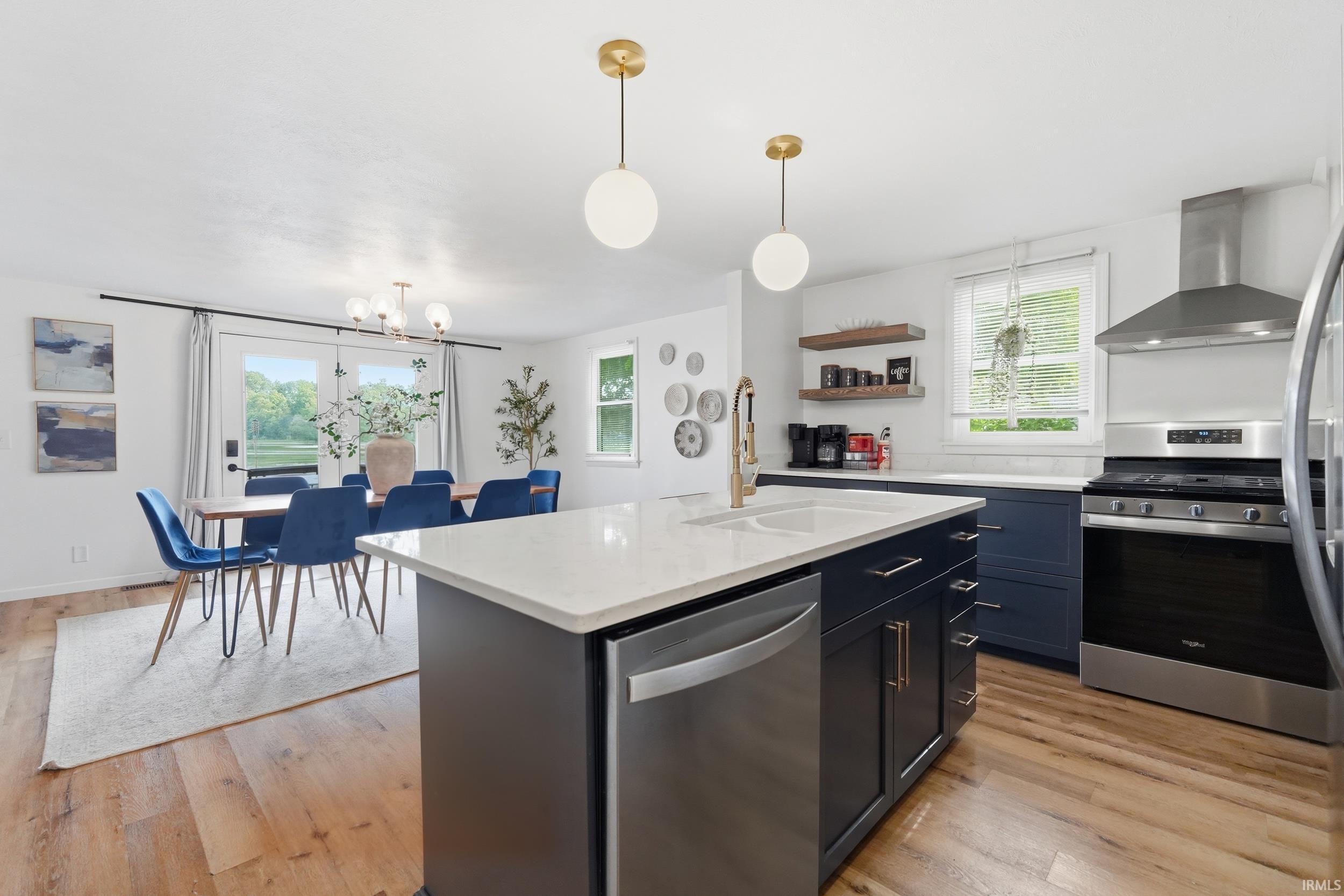 Open-concept kitchen and dining area featuring wood-finish flooring