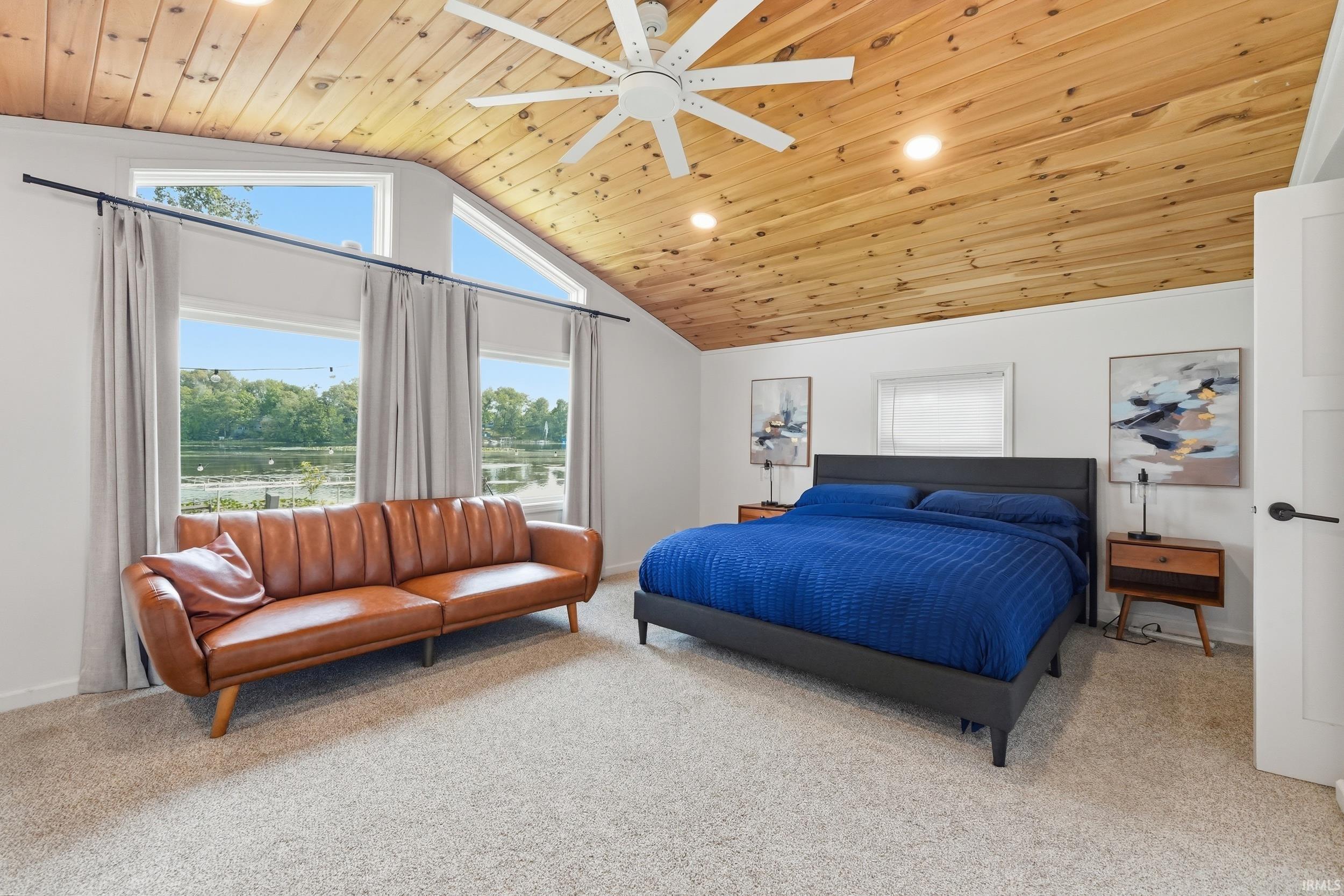 Vaulted wood-paneled ceiling with recessed lighting and ceiling fan
