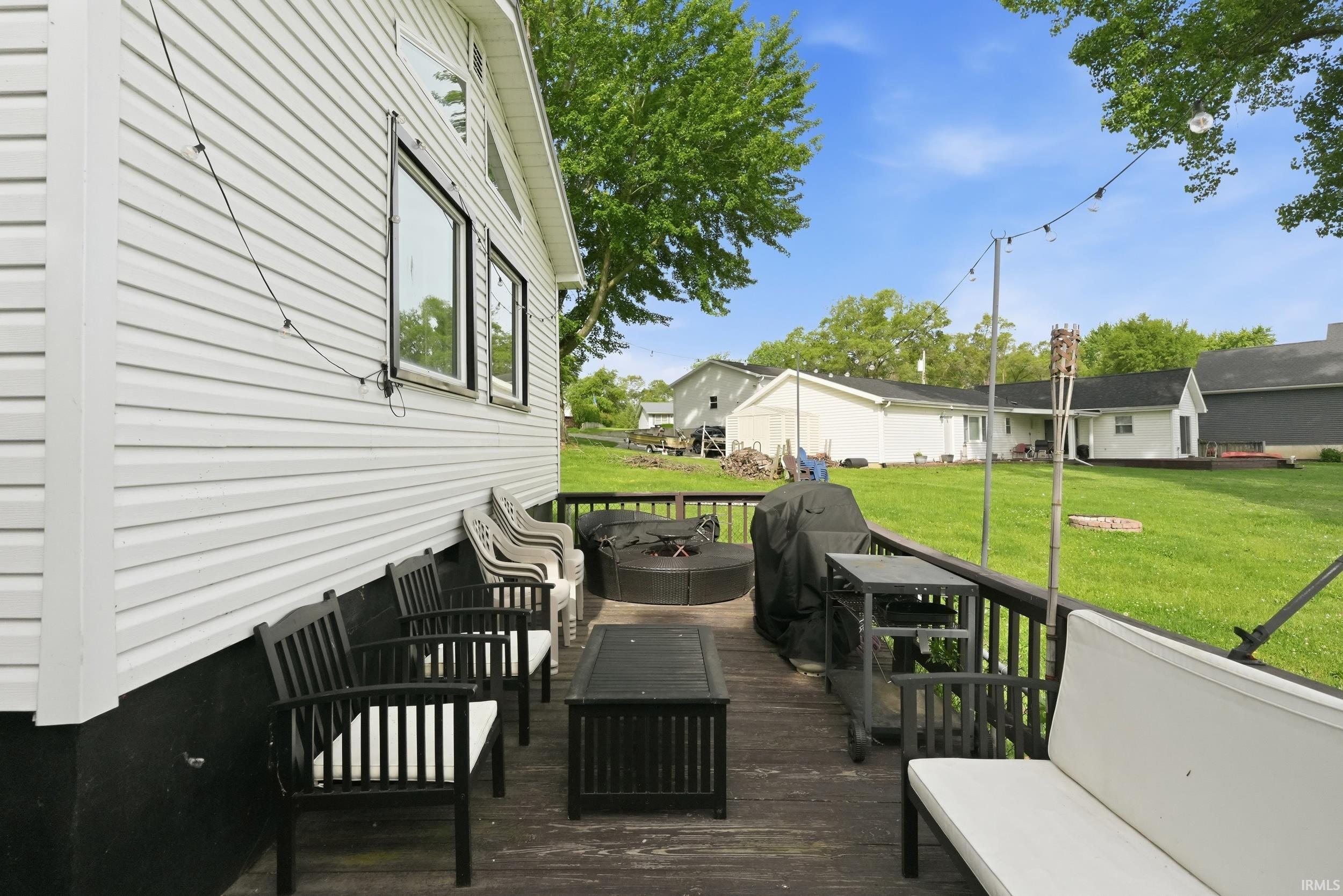 Expansive outdoor deck featuring wood flooring and a dark wood railing