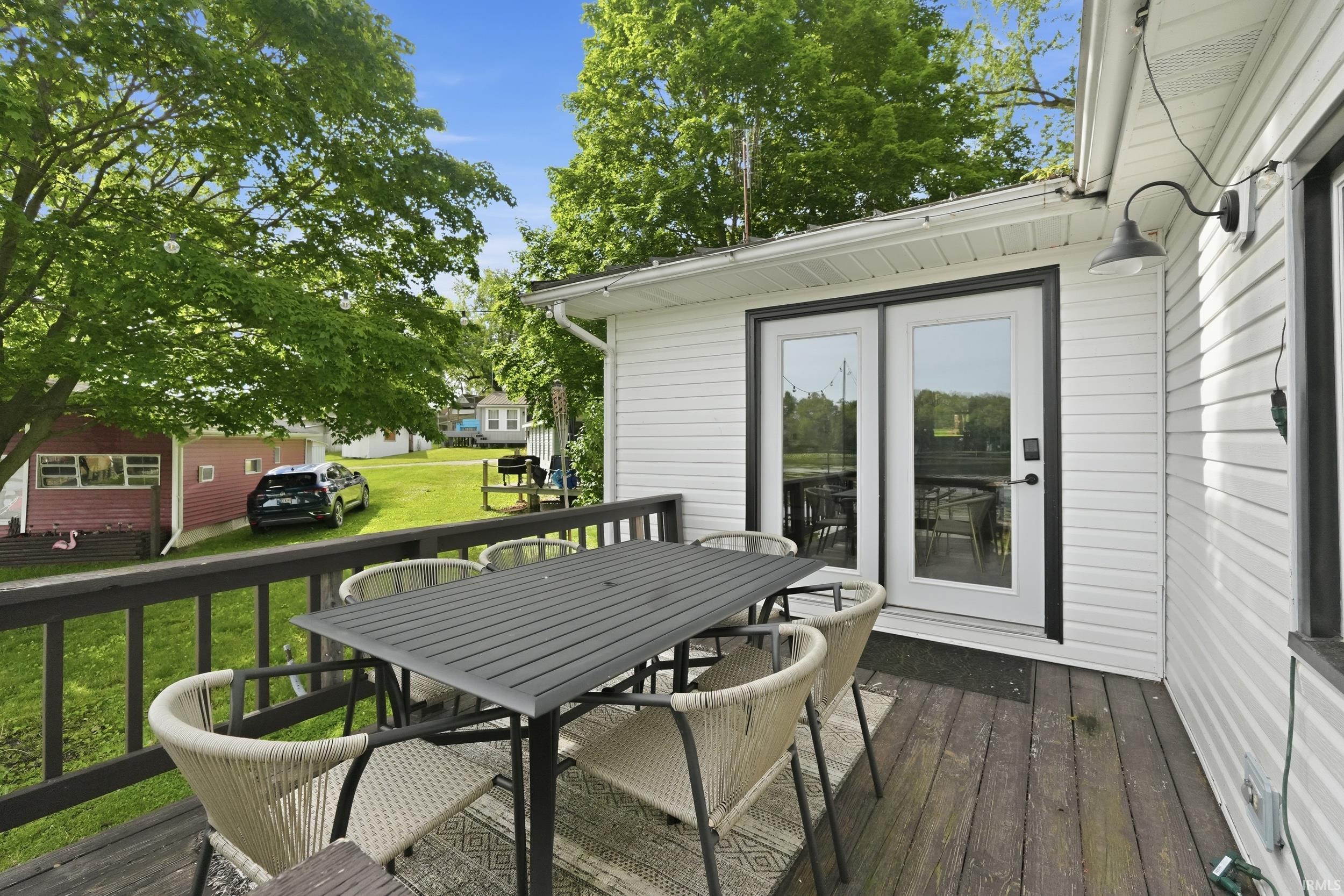 Outdoor deck with dark wood-finish flooring and black railing
