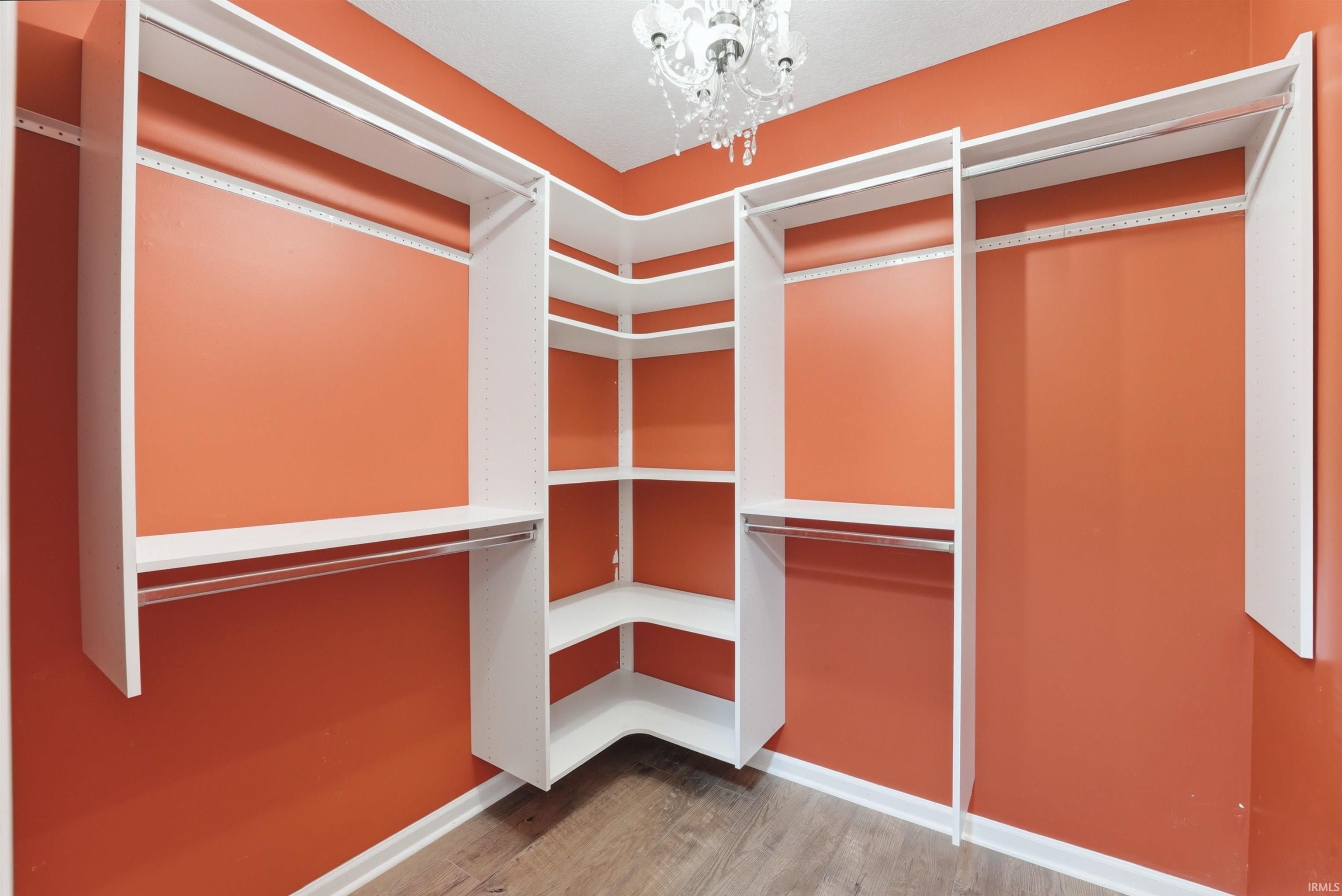 Custom closet system featuring white shelving and hanging rods