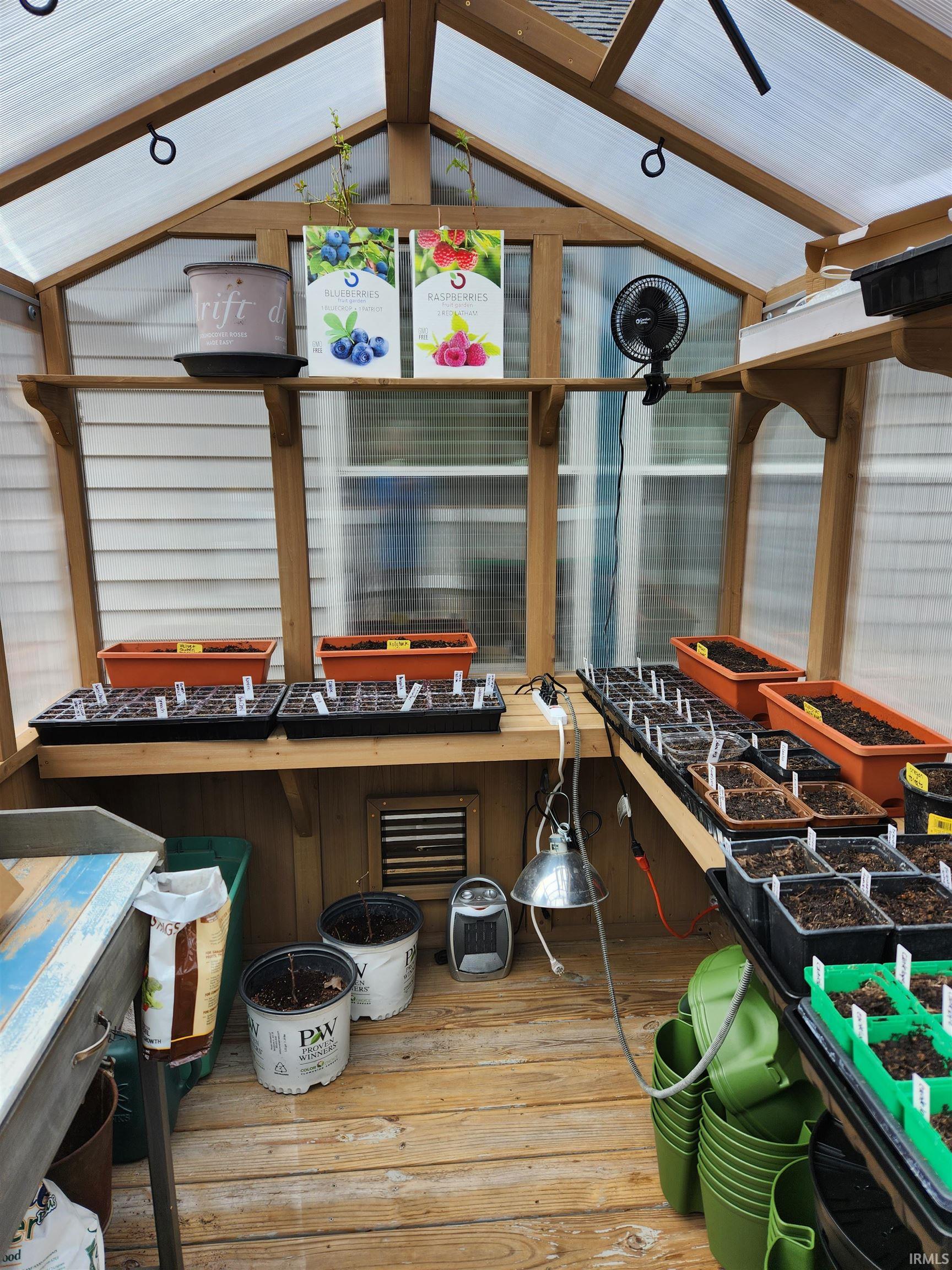 Dedicated greenhouse structure featuring a wood frame and translucent panel roofing
