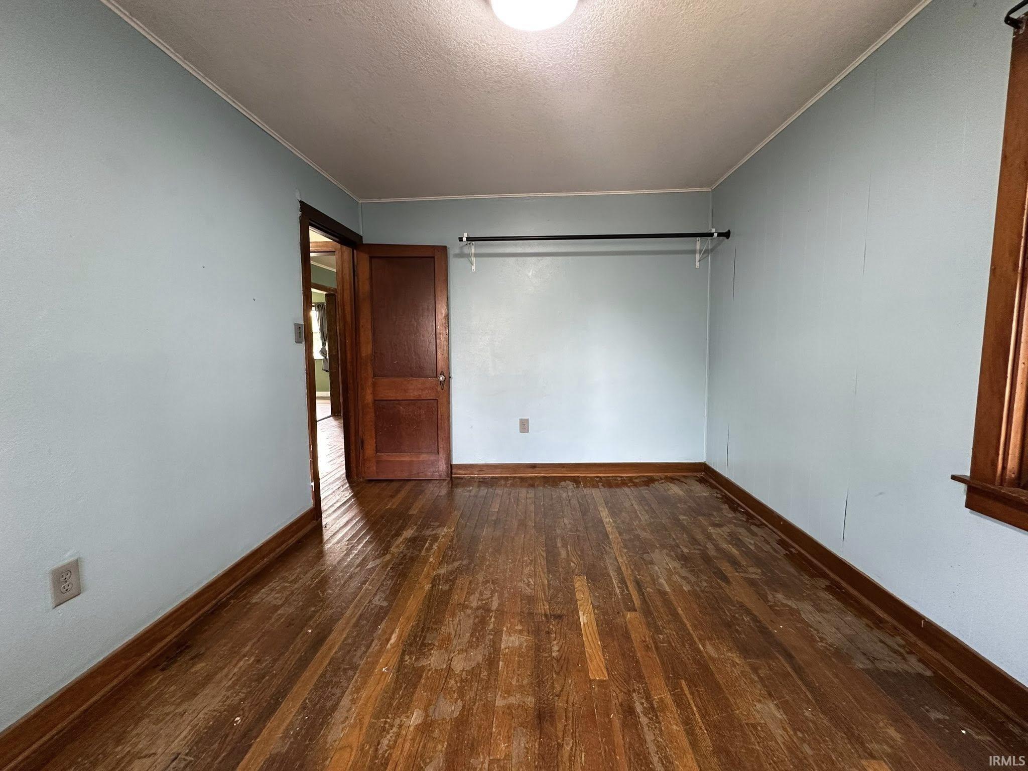 Light blue walls with wood-finish flooring