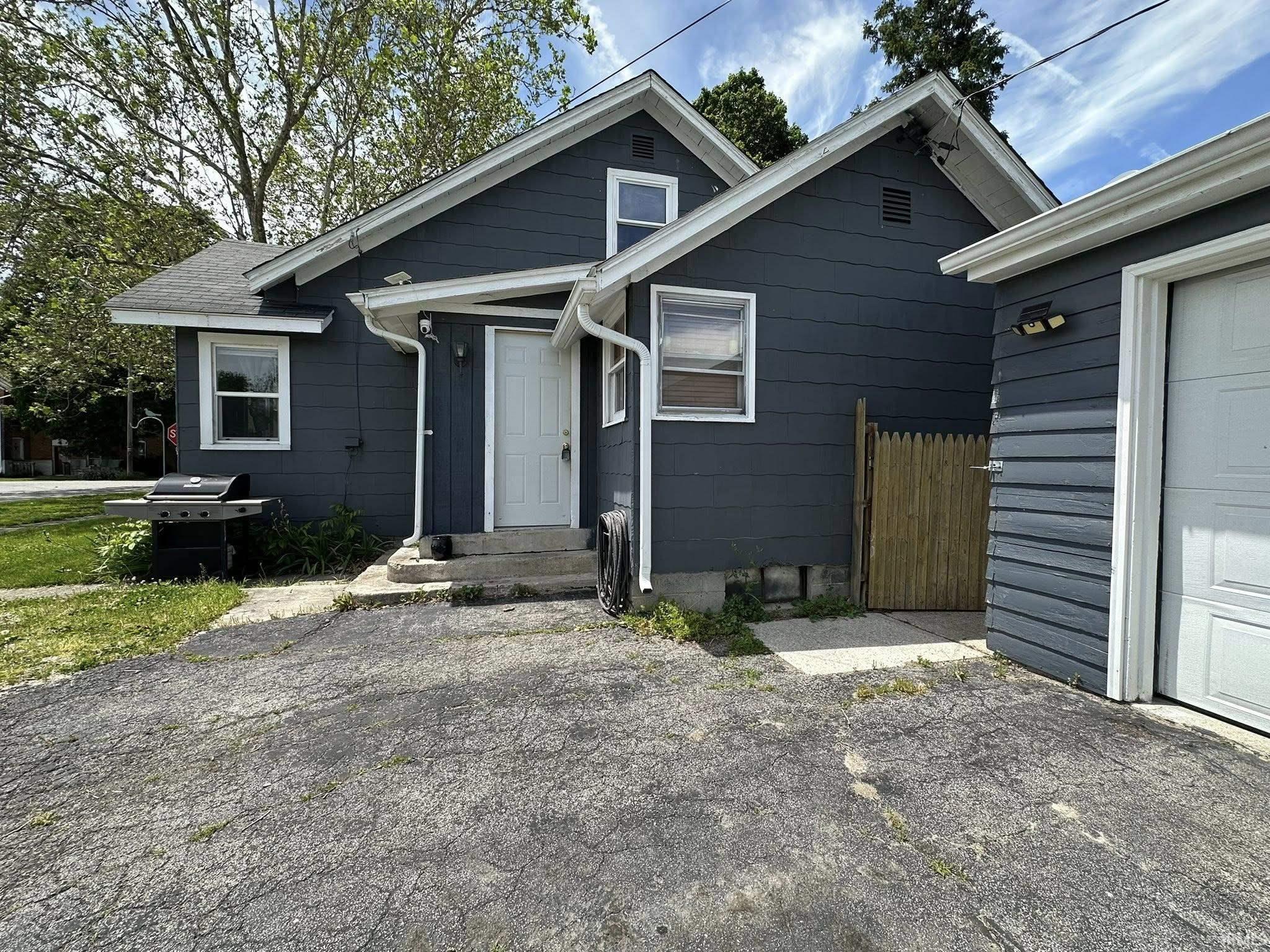 Dark blue siding exterior with white trim and white gutters