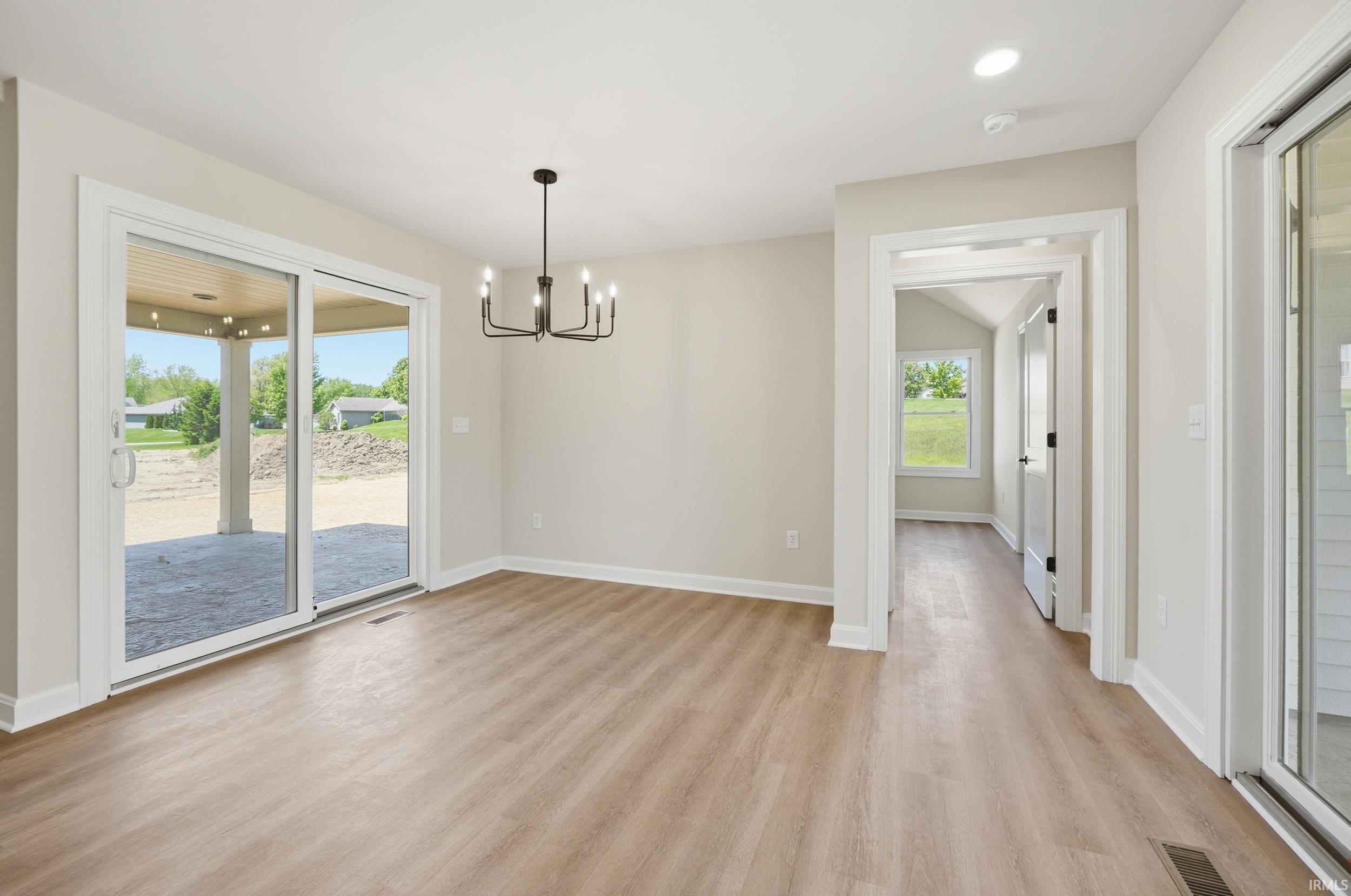 Spacious interior with wood-finish flooring and neutral wall tones