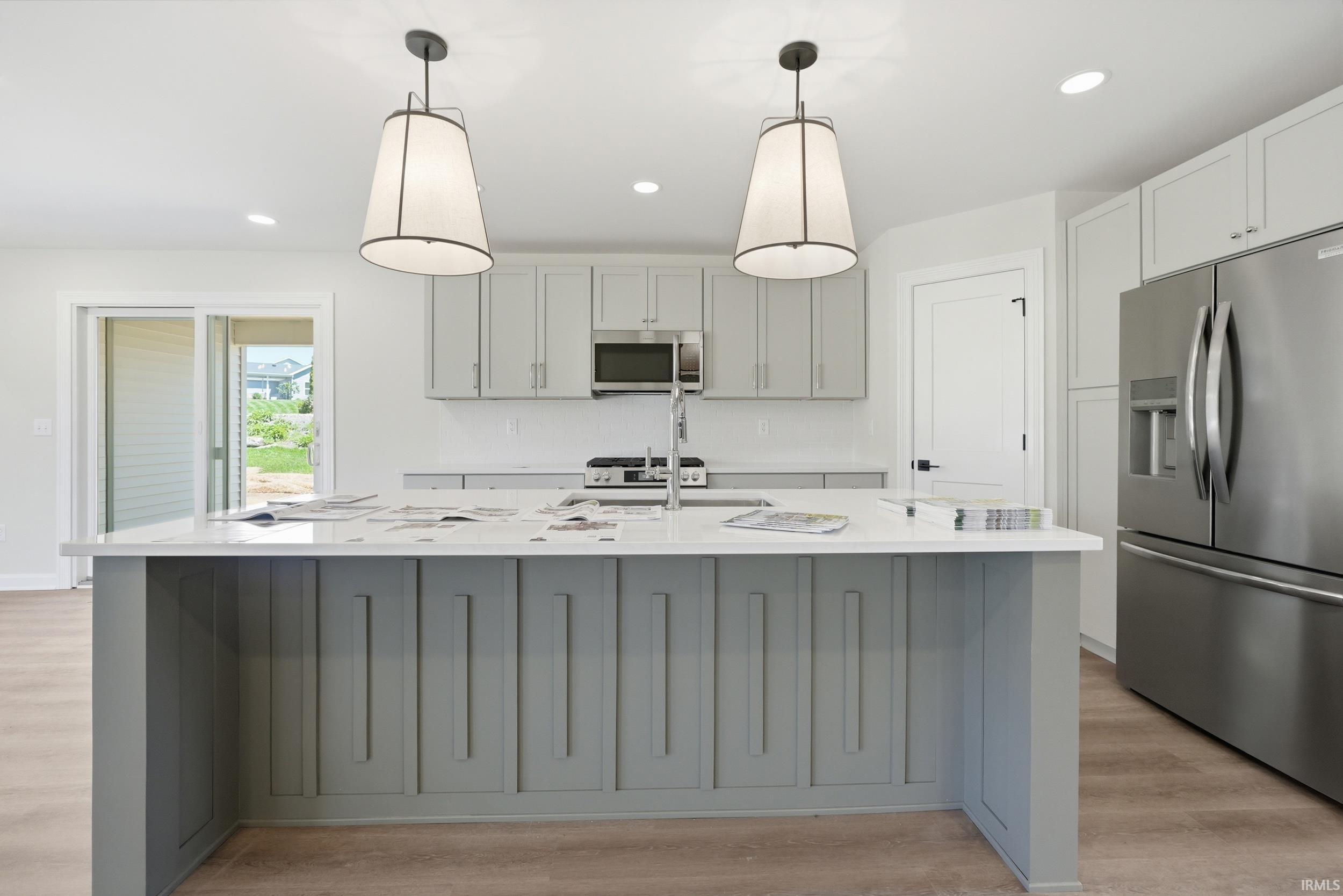 Central kitchen island with a white countertop and grey paneled base