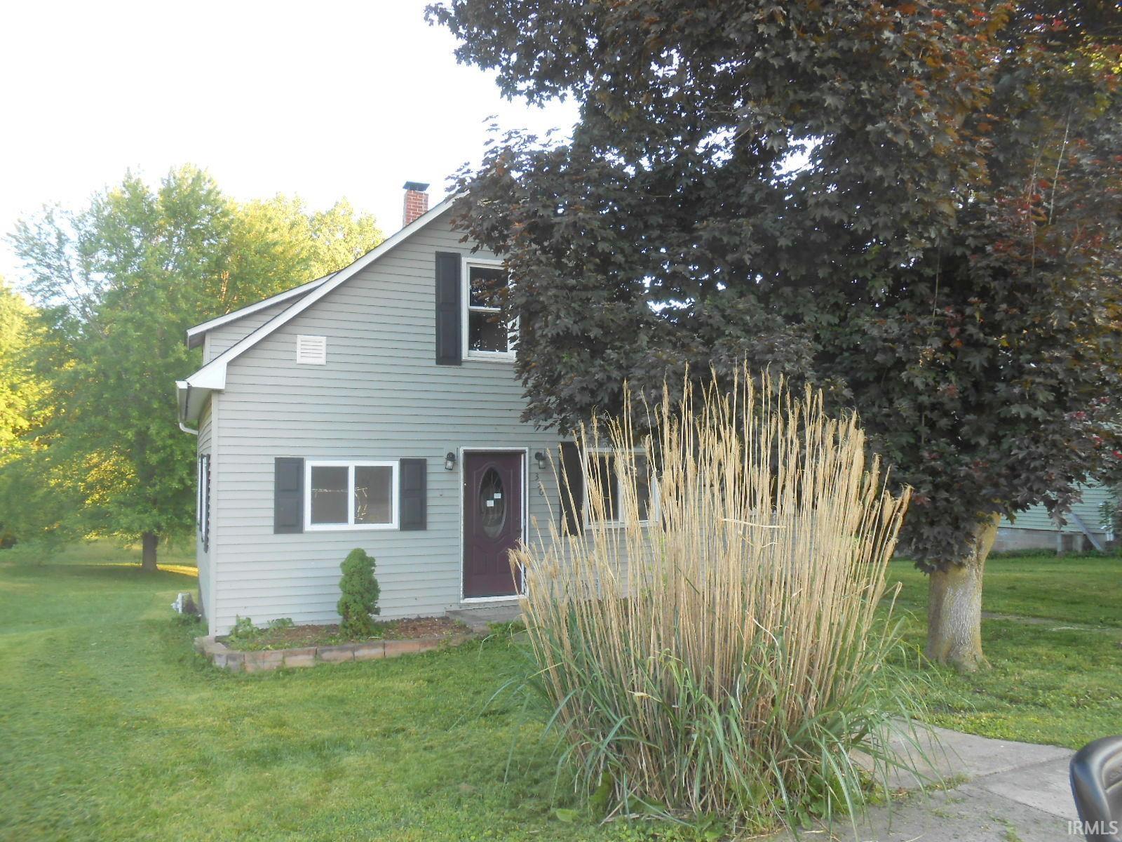 Light gray siding exterior with dark shutters