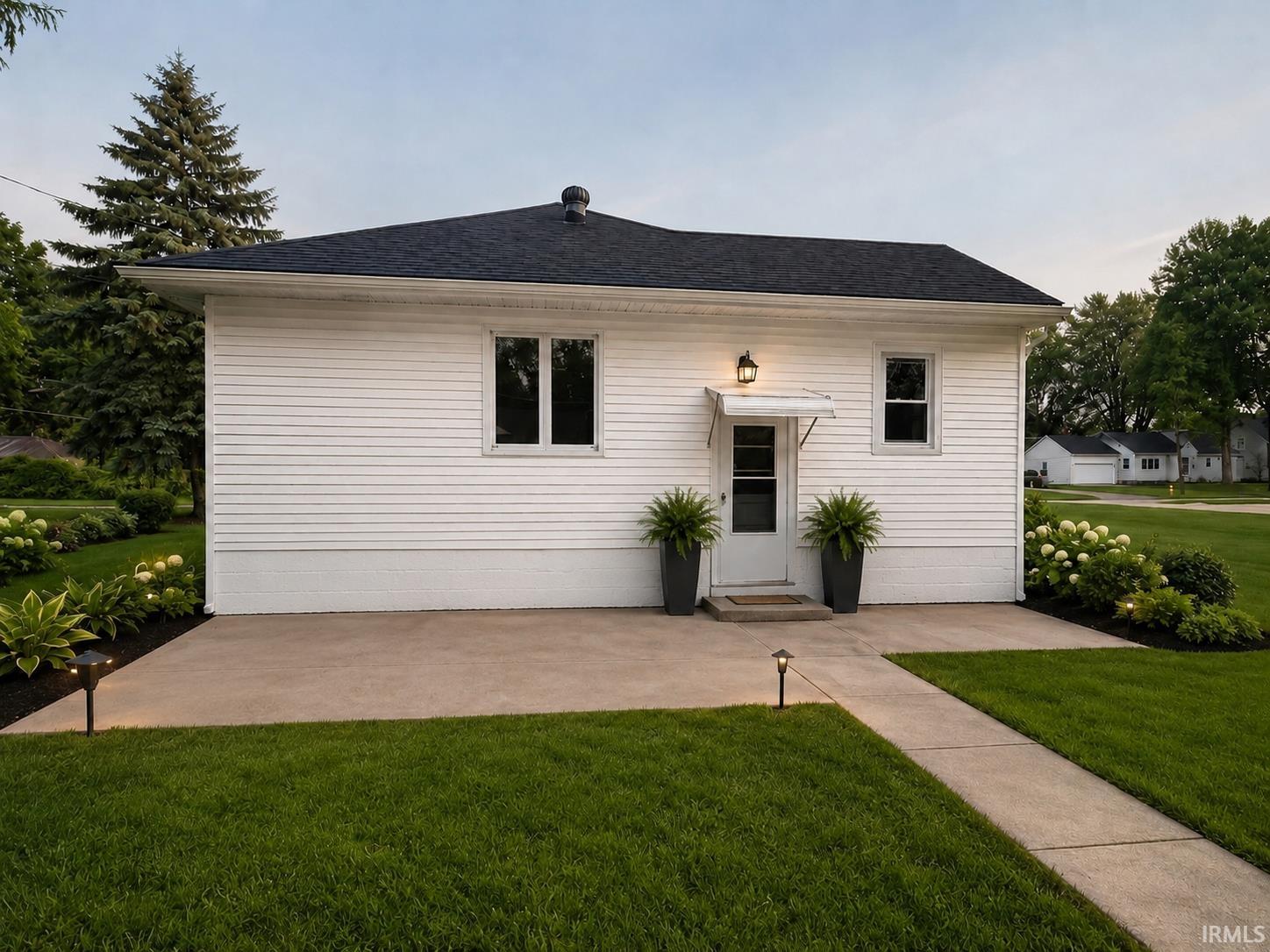 White siding exterior with a dark shingle roof
