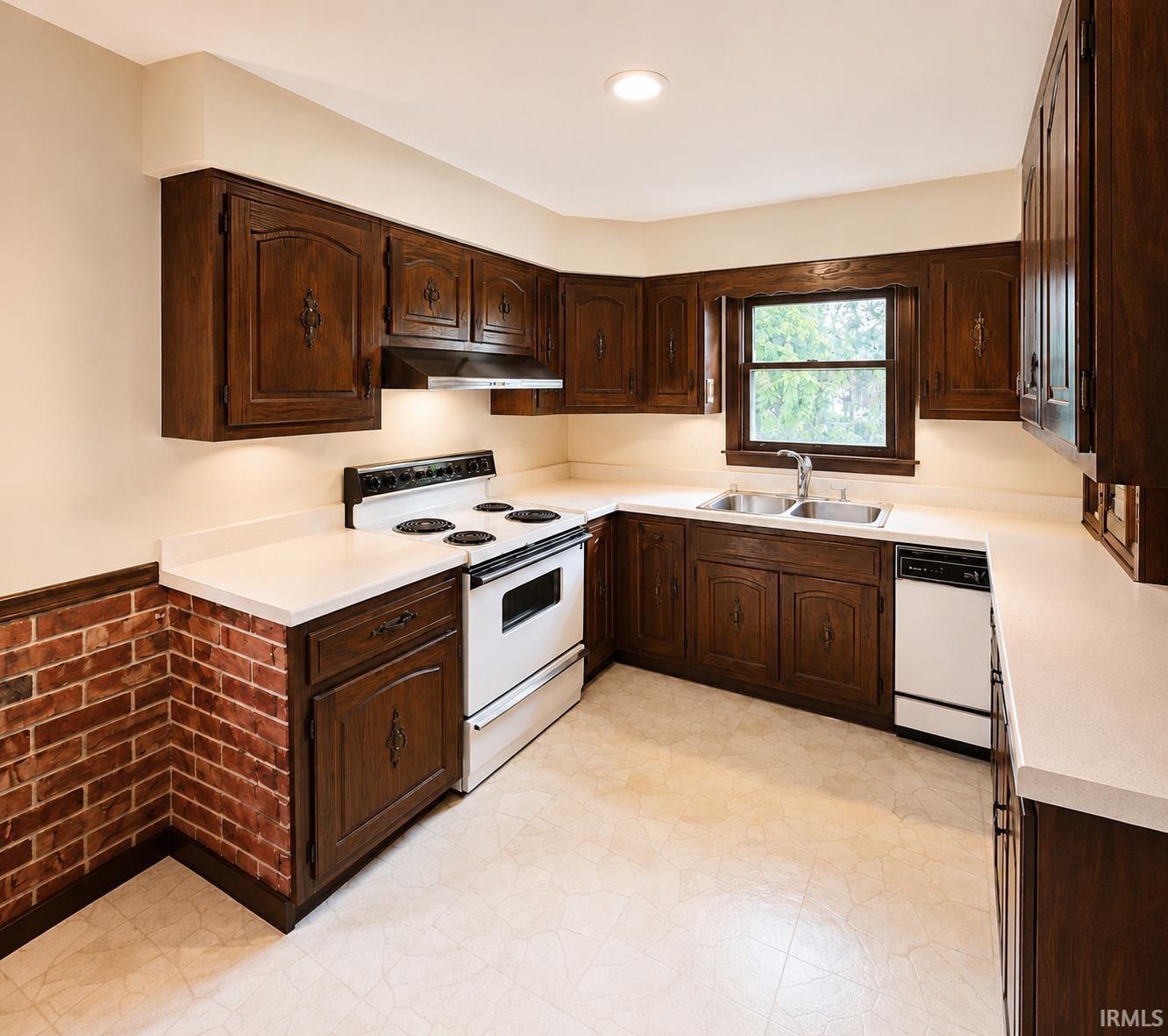 Kitchen featuring dark wood cabinetry, light-toned countertops, and a white electric range with matching dishwasher ( Dishwasher dose not work)Grabill Custom made Amish cabinets