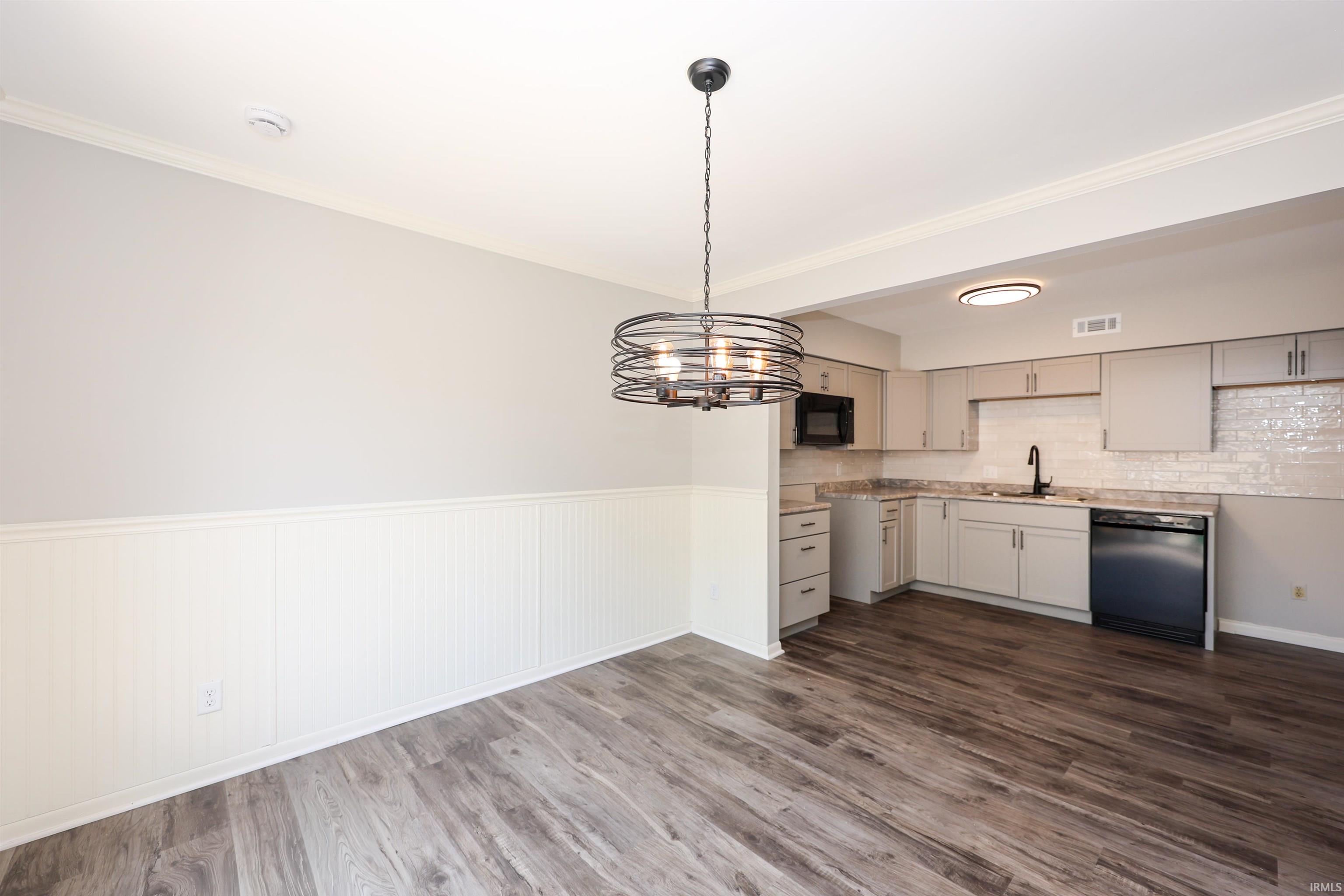 Dining area with wood-finish flooring and wainscoting