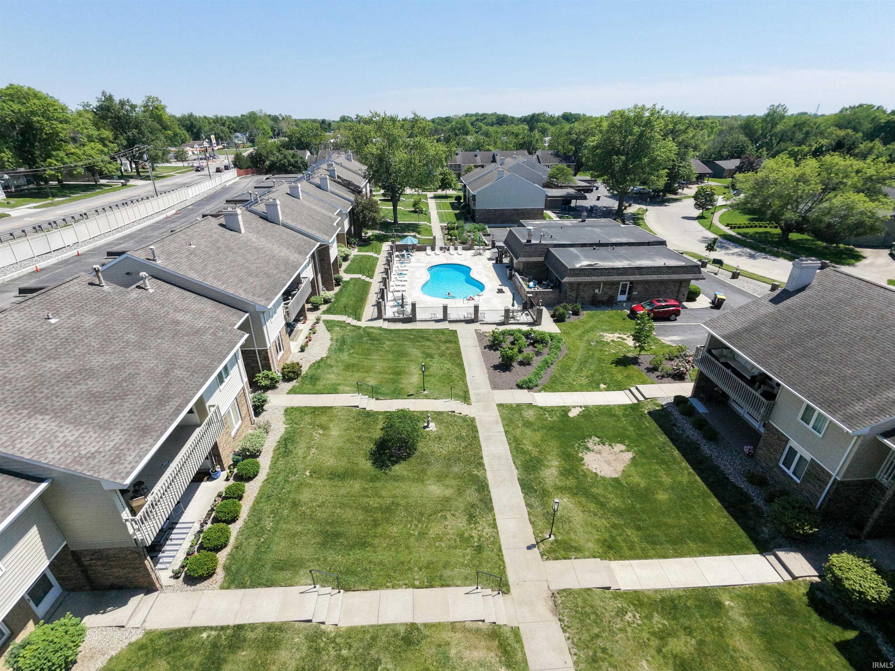 Central courtyard with an inground swimming pool surrounded by a concrete deck and lounge seating