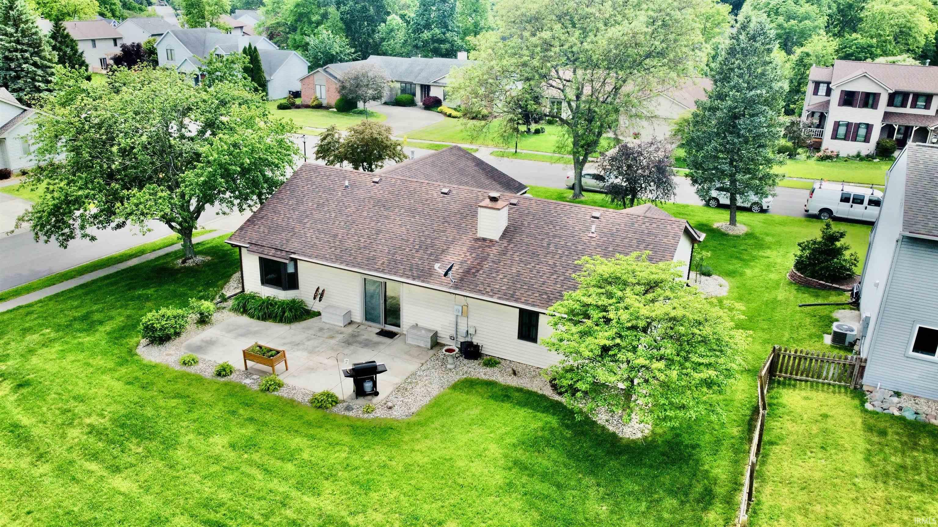 Rear exterior featuring a patio, sliding glass door, and a chimney