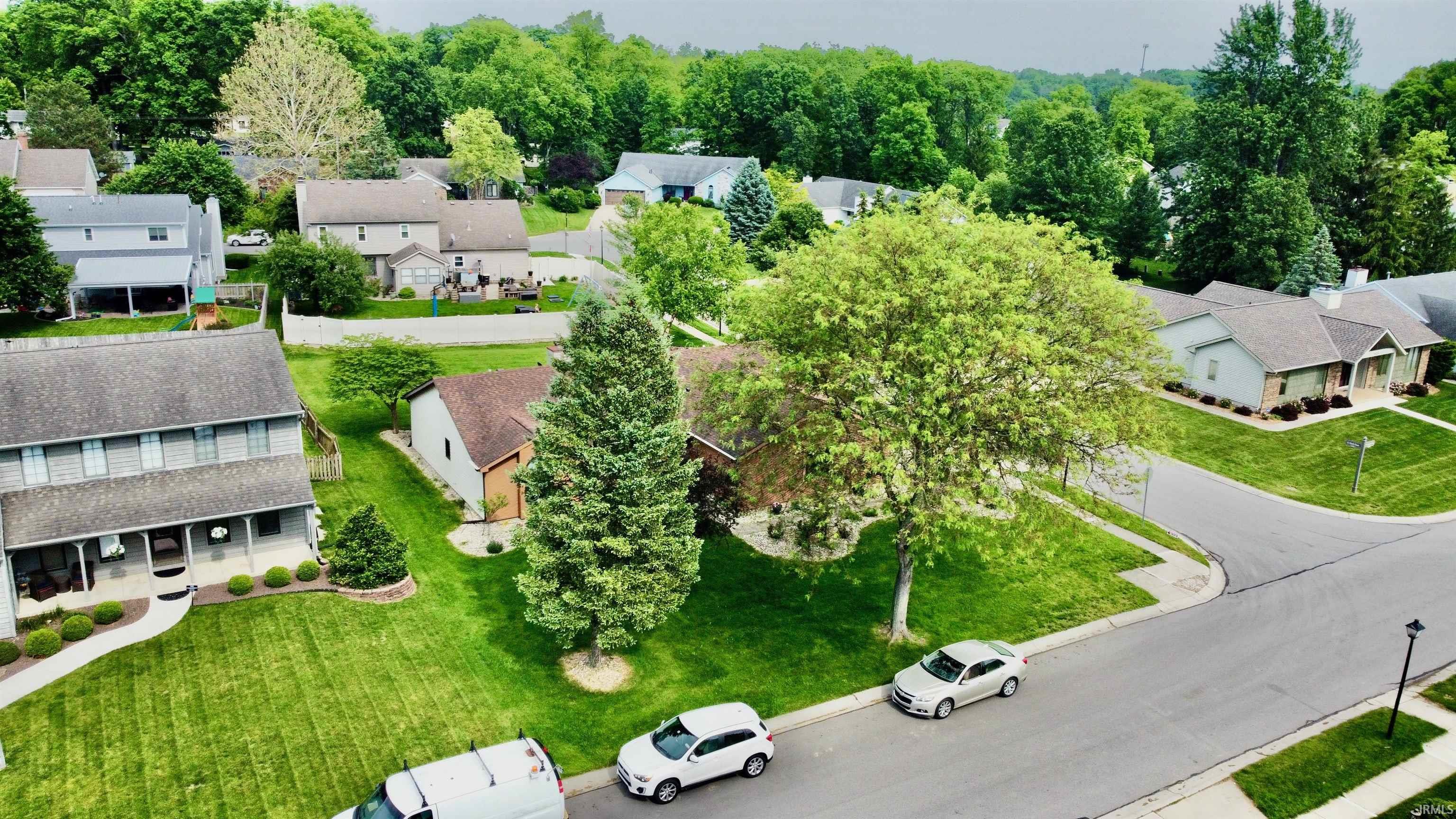 Residential neighborhood featuring mature trees and manicured lawns