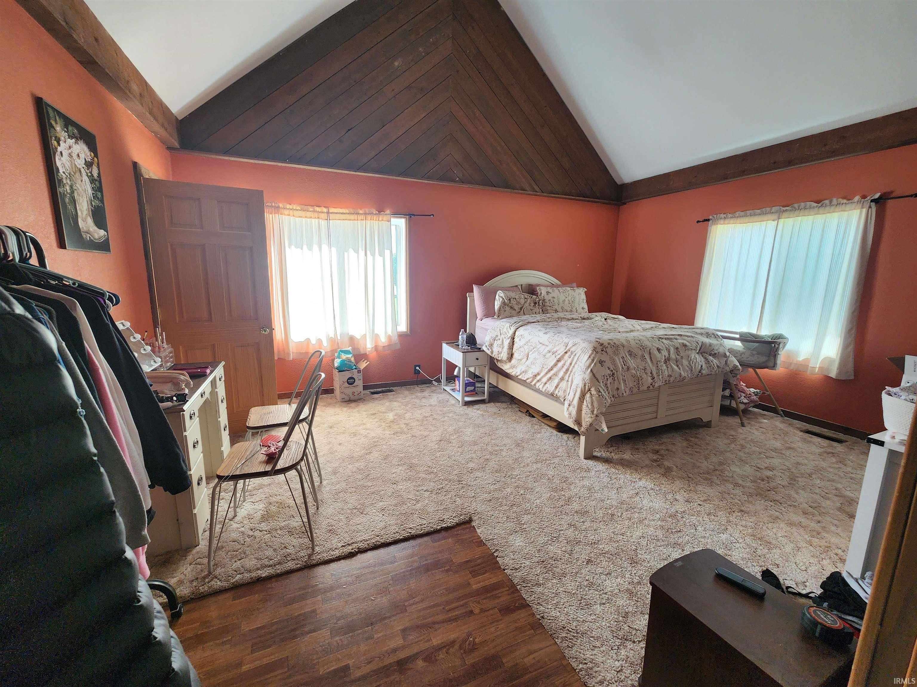 Vaulted wood-paneled ceiling with exposed beams