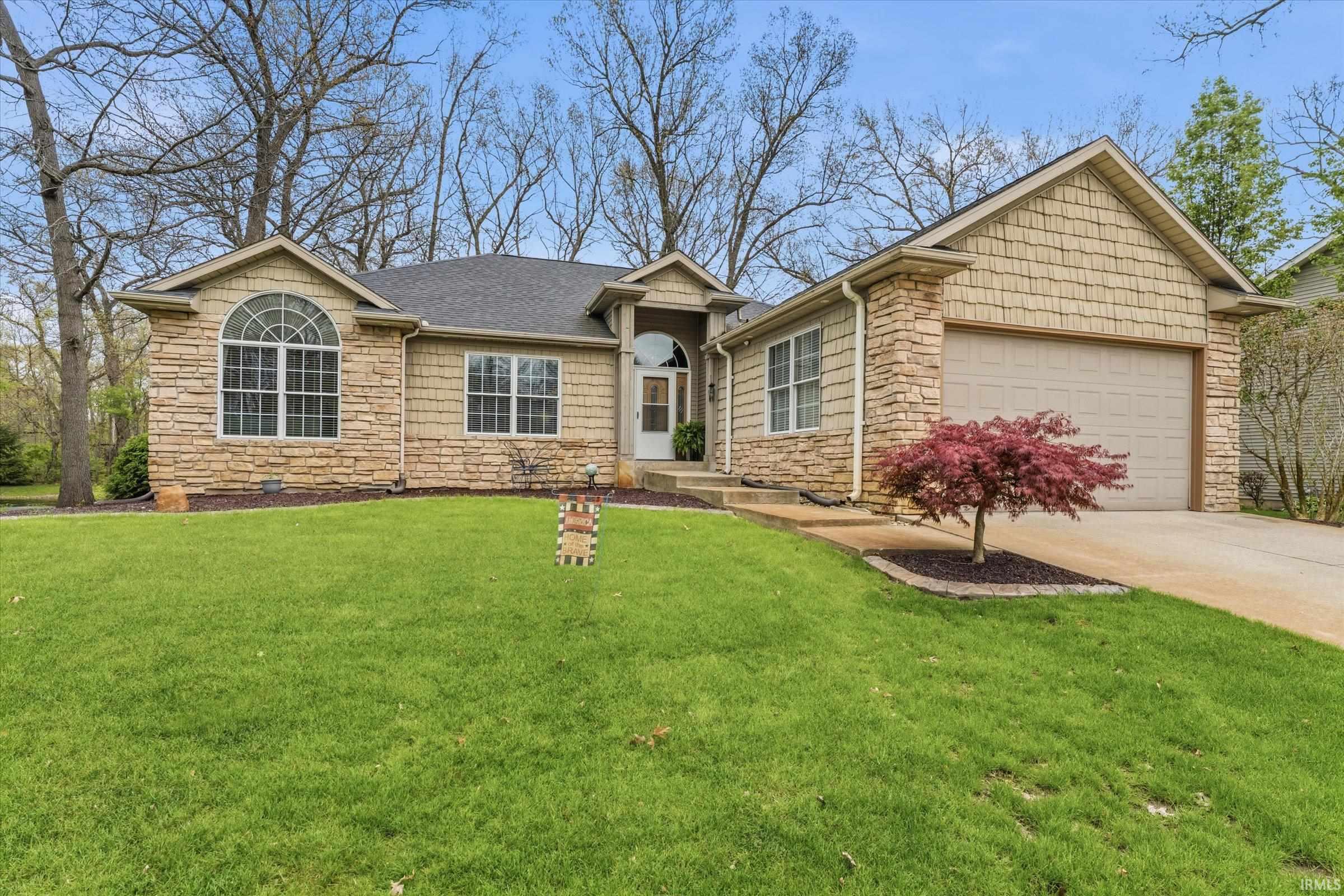 Stone and shingle exterior with an arched window accent