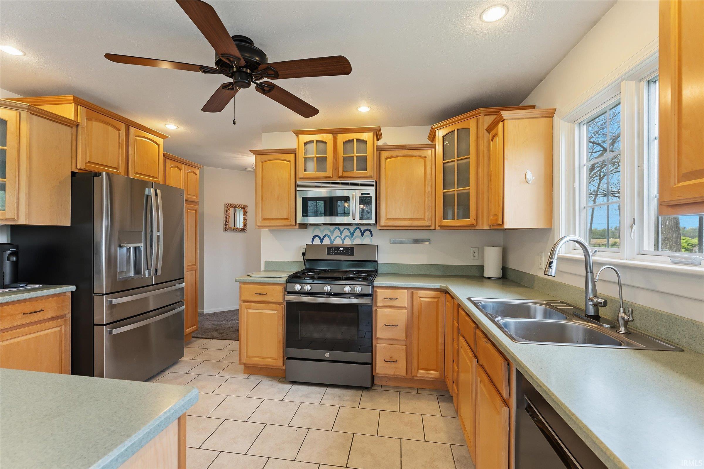 Kitchen featuring wood cabinetry, stainless steel appliances, and light-toned countertops