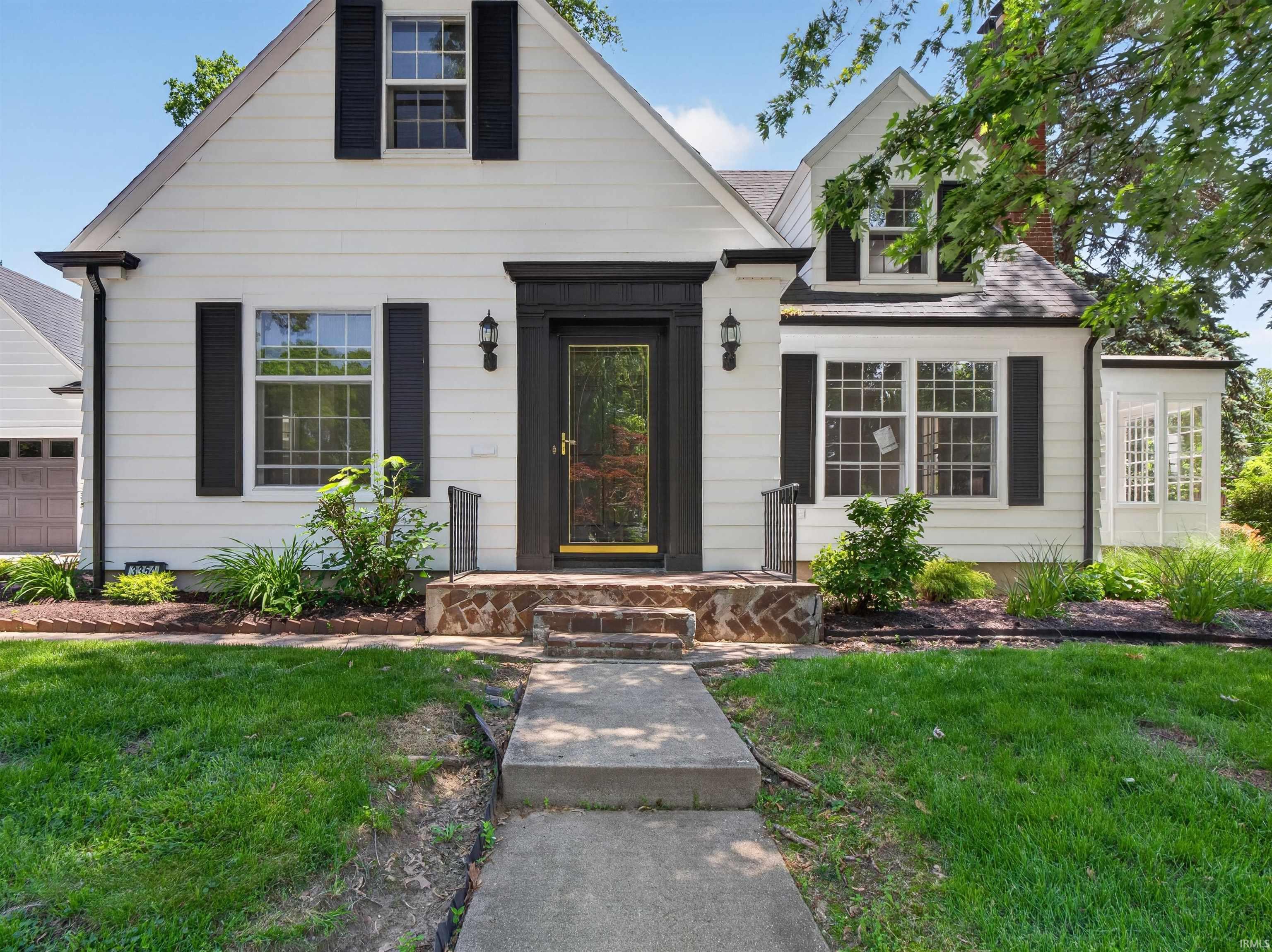 White siding exterior with black shutters and trim