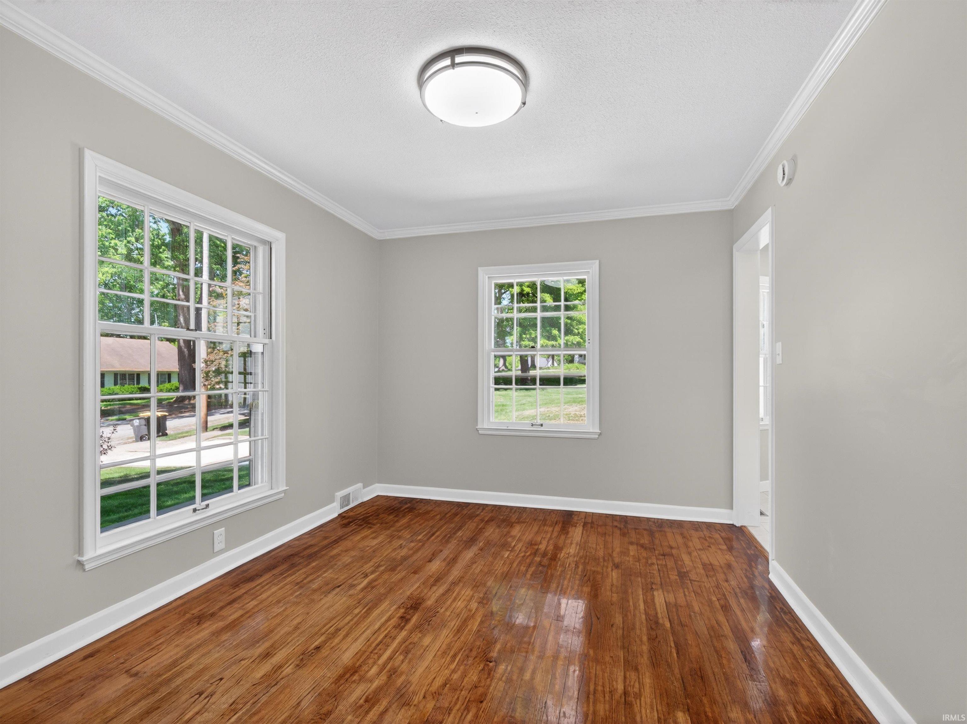 Bright interior space featuring a large window with multiple panes, providing abundant natural light
