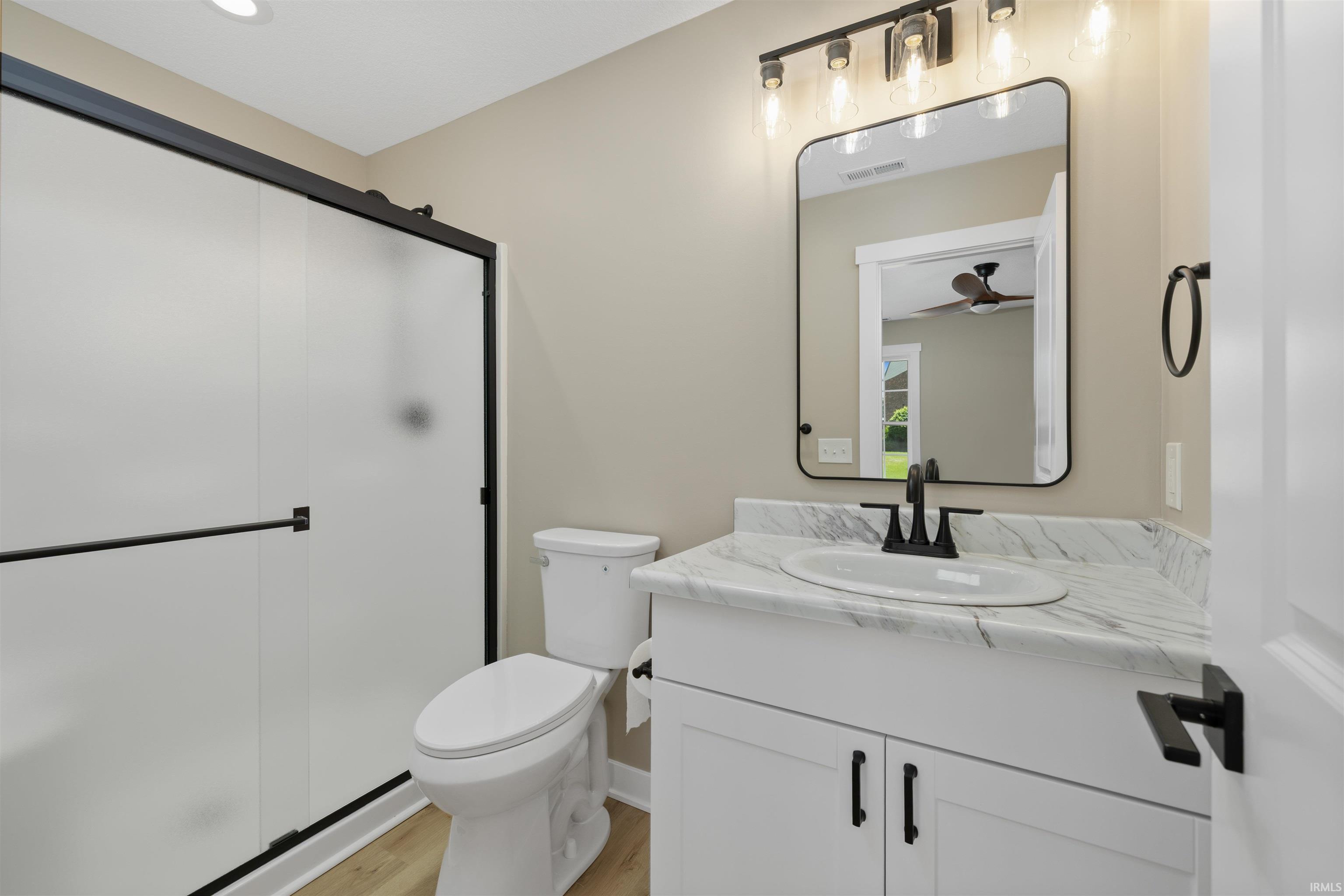 Bathroom featuring a contemporary vanity with a white countertop and oval under-mount sink