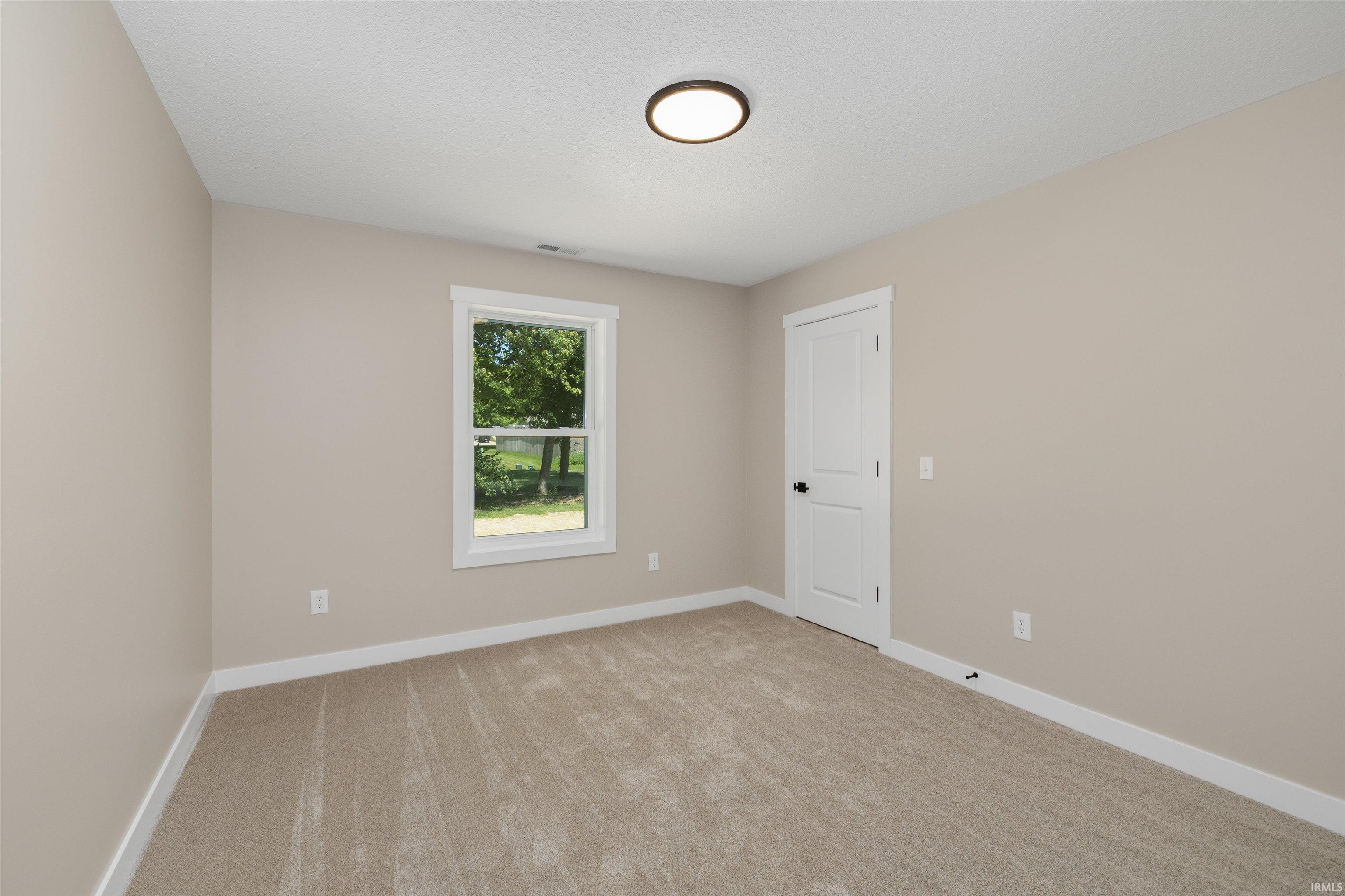Neutral-toned walls complementing plush carpet flooring