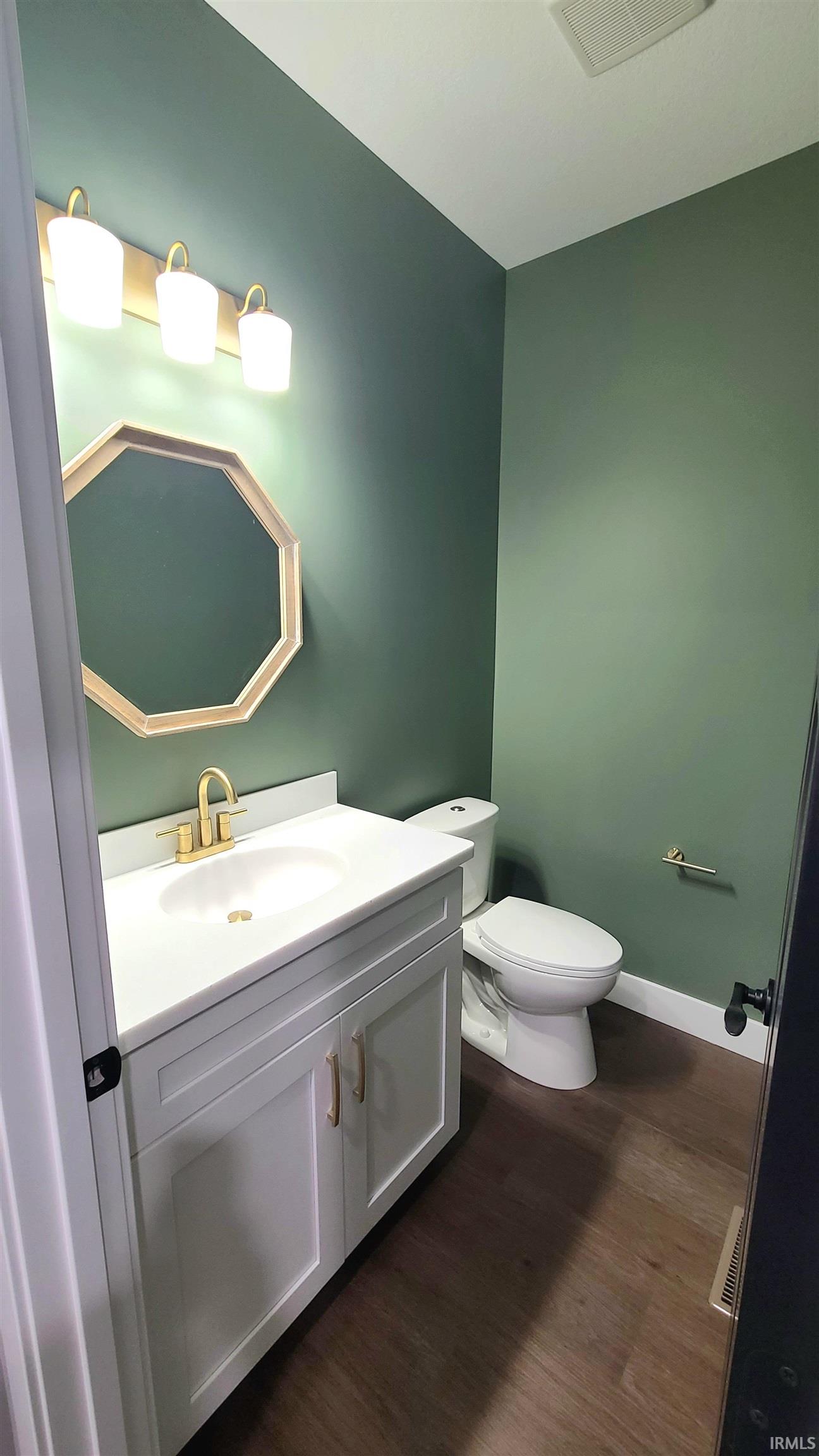 Bathroom featuring deep green walls