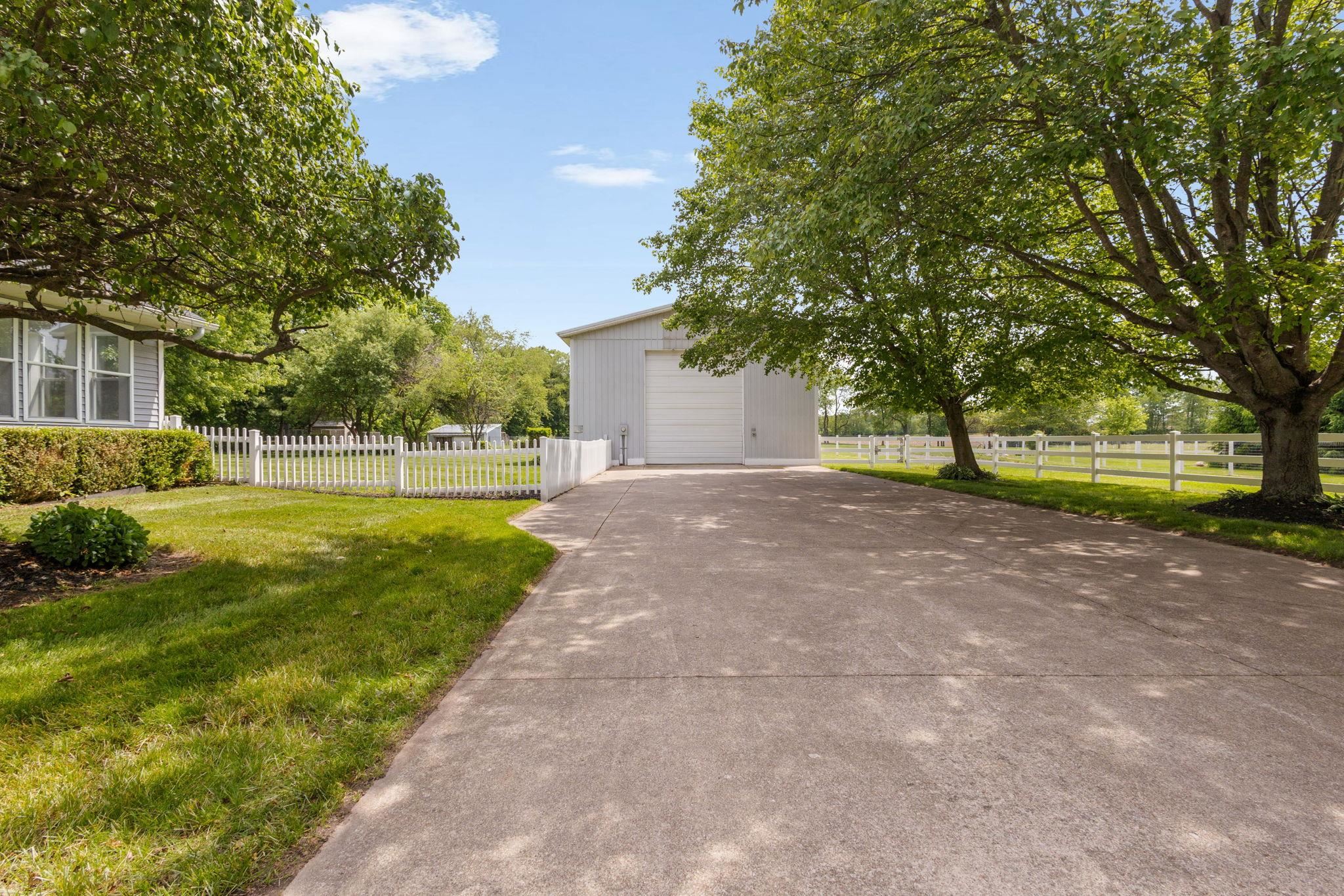 Concrete drive leading to a detached garage