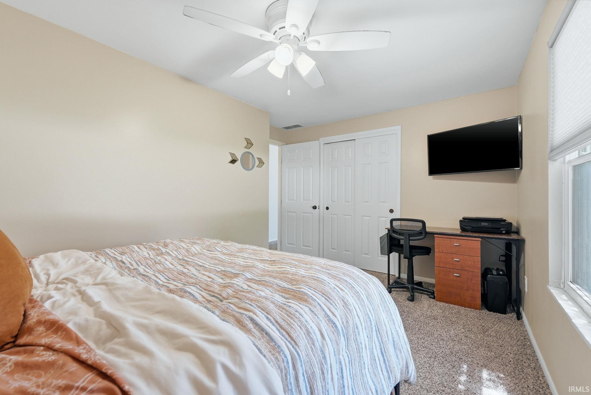 Neutral tone walls complement the light-colored carpeted flooring