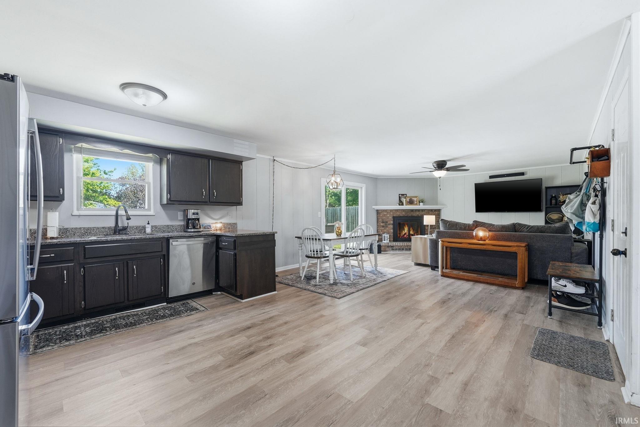 Open-concept interior featuring light wood-finish flooring throughout