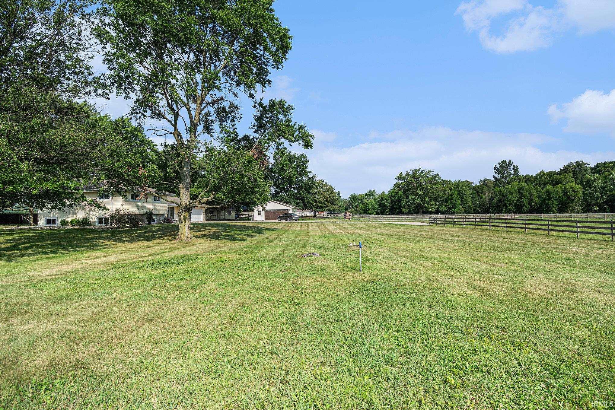Expansive green lawn with a perimeter fence