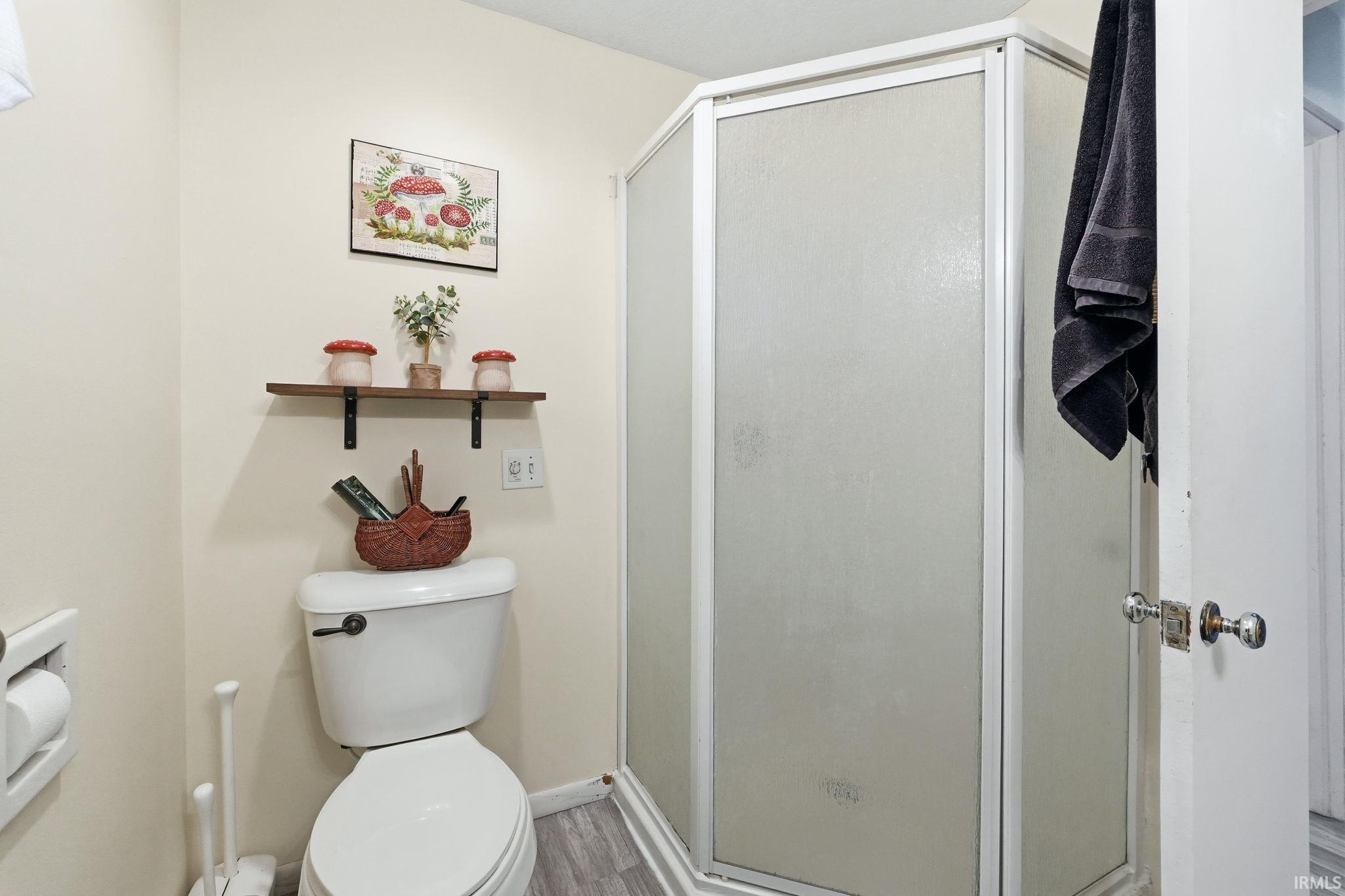 Corner shower enclosure with frosted glass panels and white trim