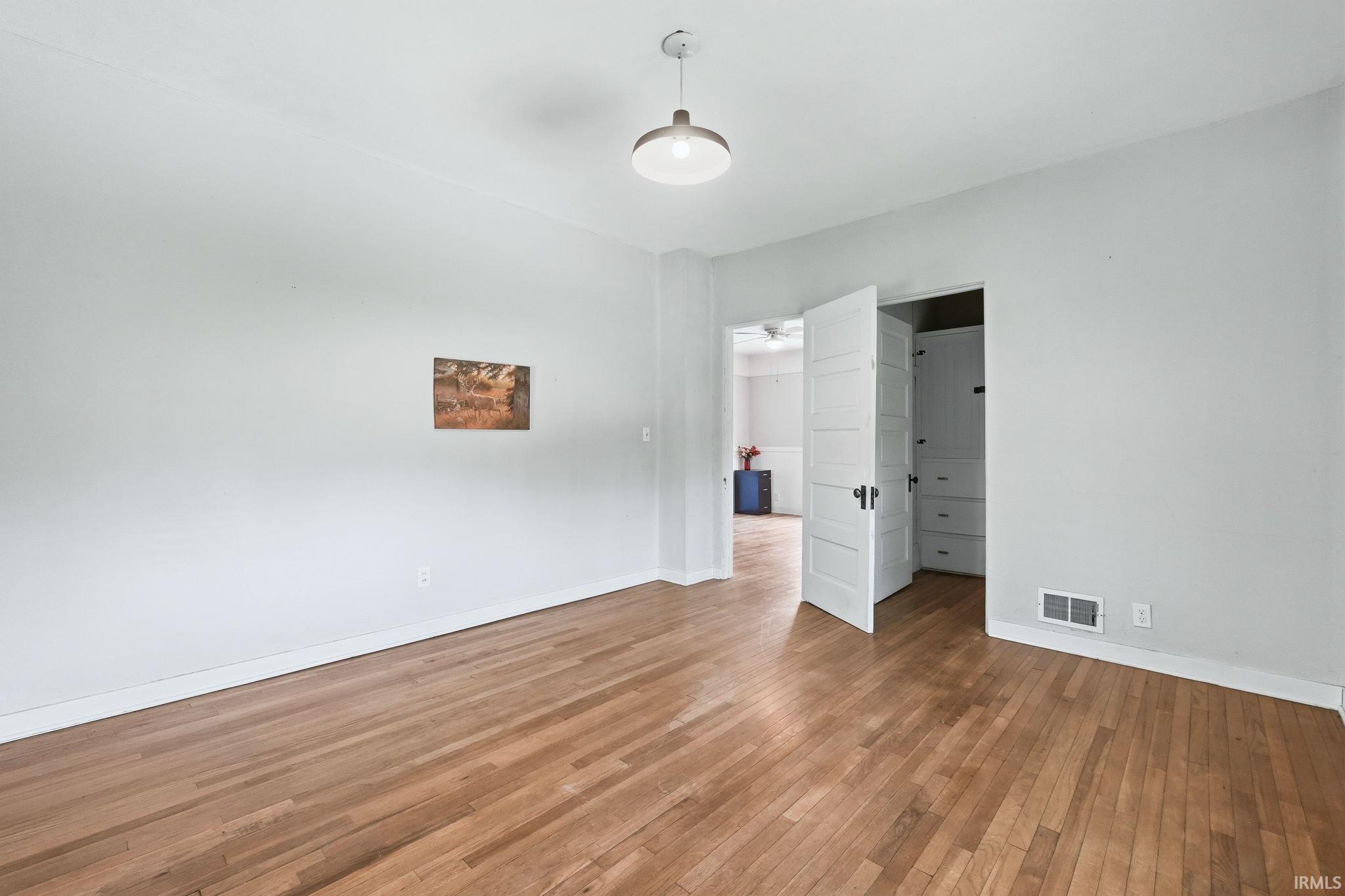 Hardwood flooring throughout, offering a durable surface