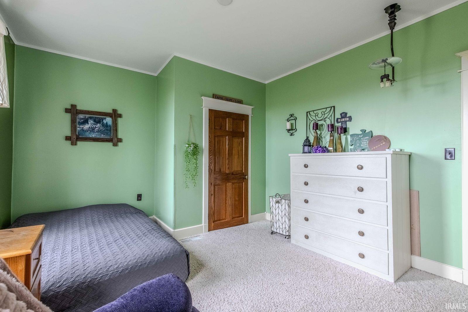 Soft green wall color with white trim and coved baseboards