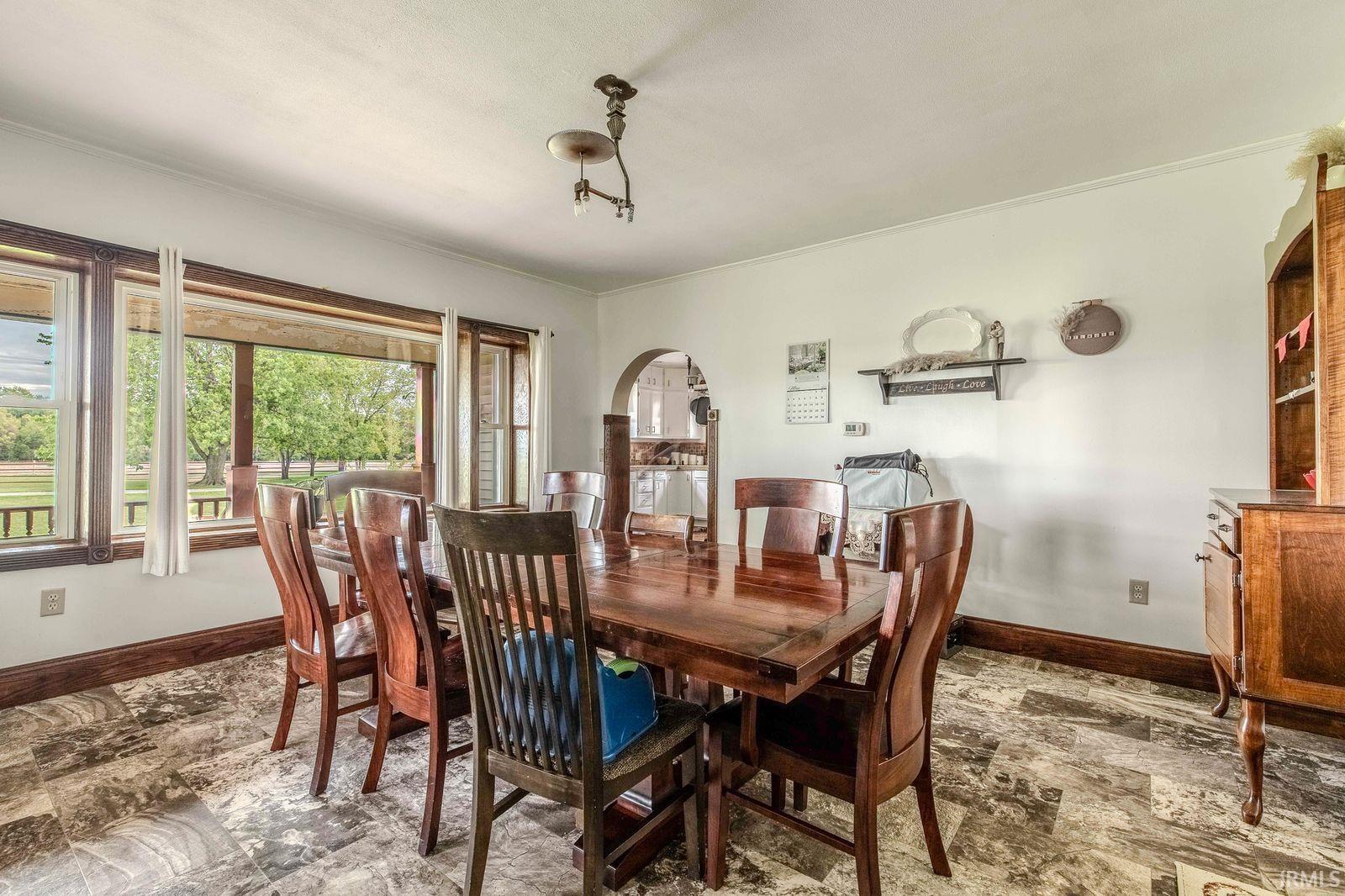 Dining area with patterned tile flooring and white walls