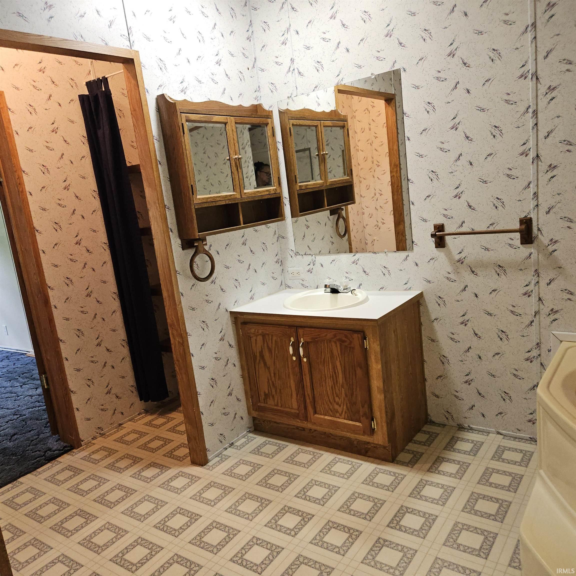Bathroom vanity with a white countertop and oval sink
