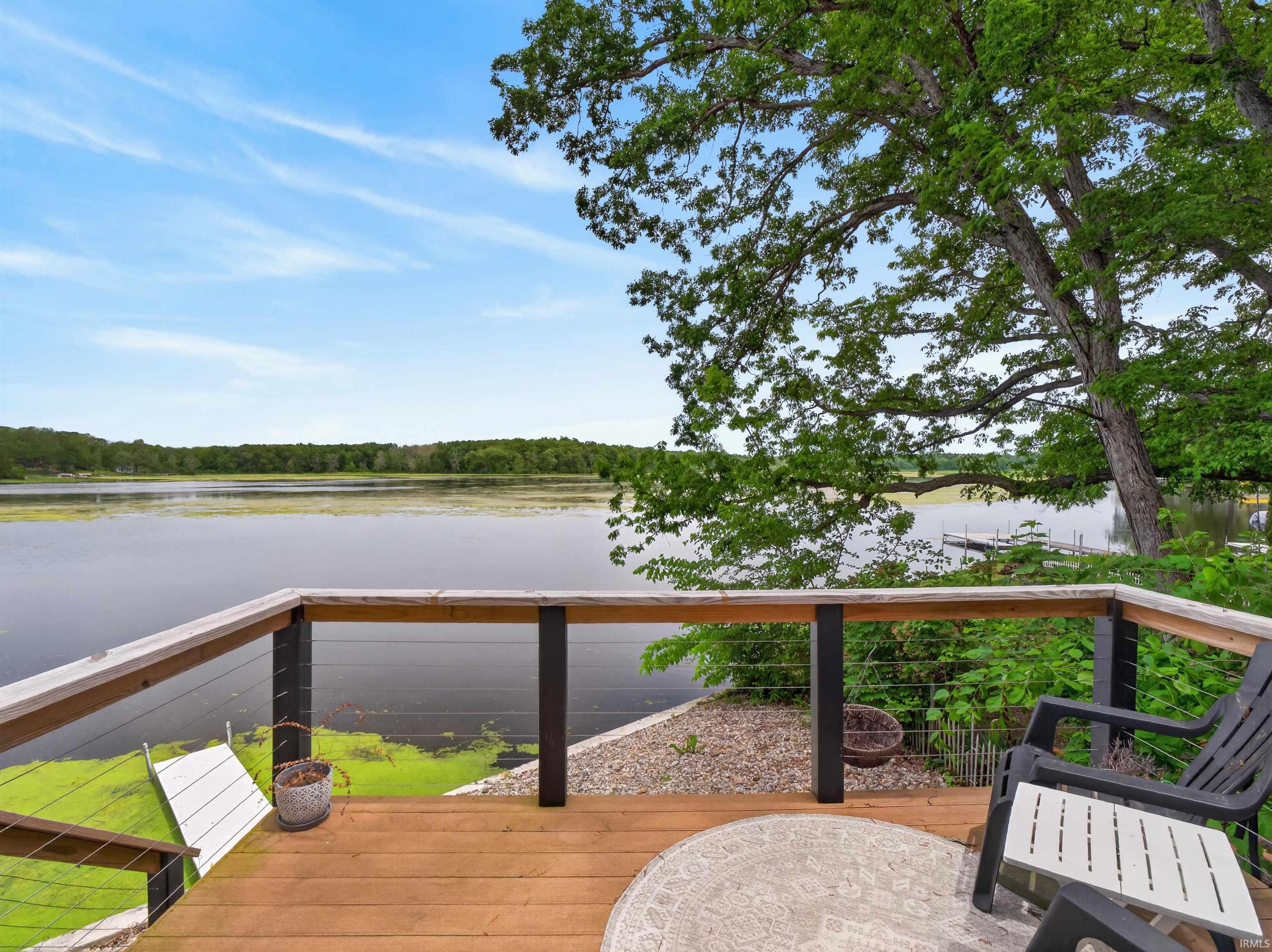 Spacious outdoor deck with wood-finish flooring and cable rail system