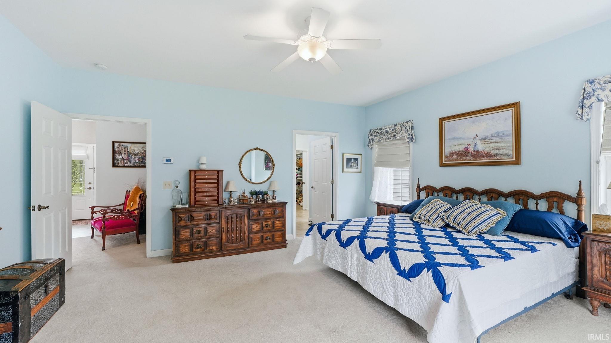 Spacious room featuring light blue walls and neutral carpet flooring