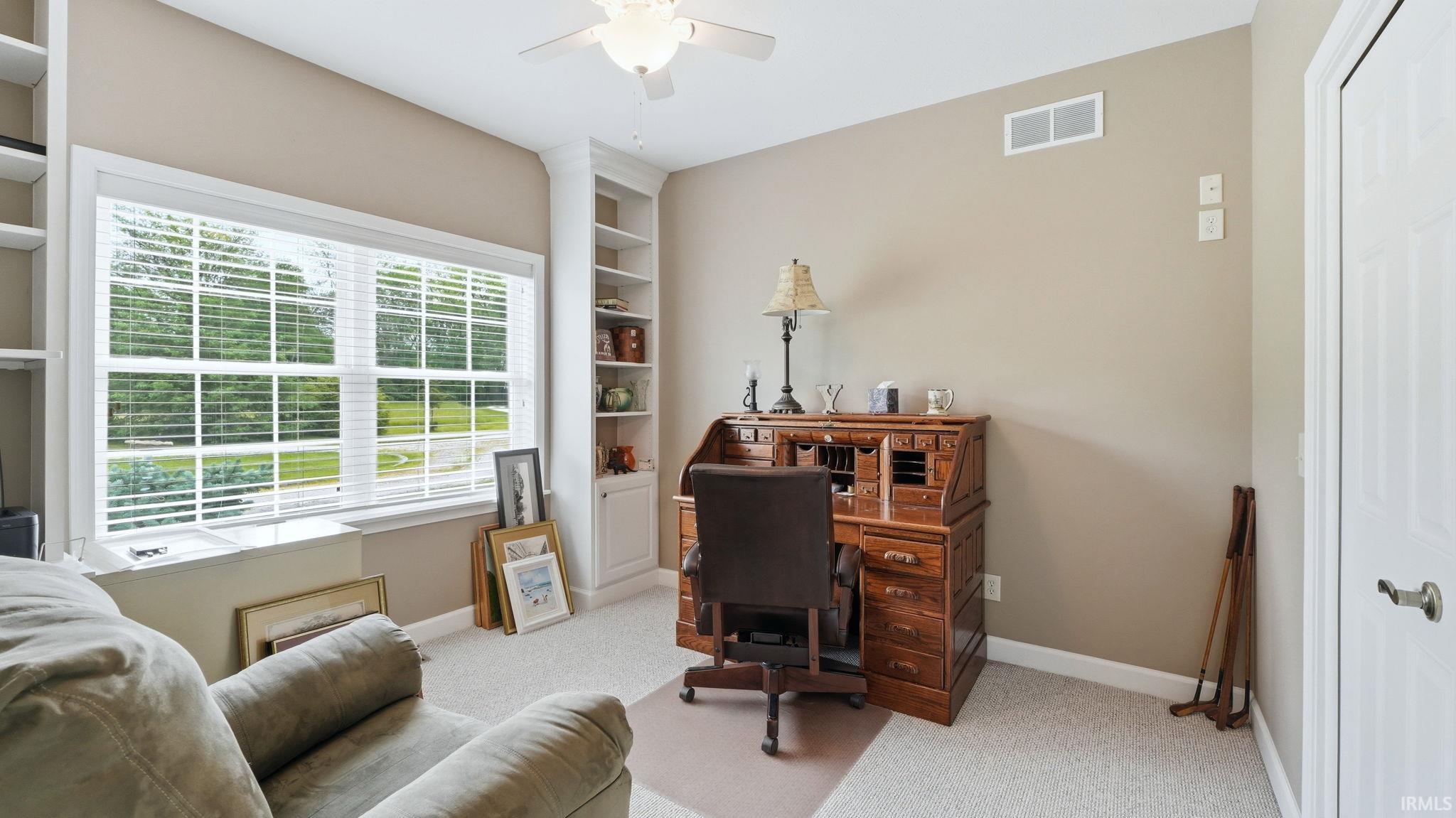 Neutral-toned room with a large window featuring white blinds and trim