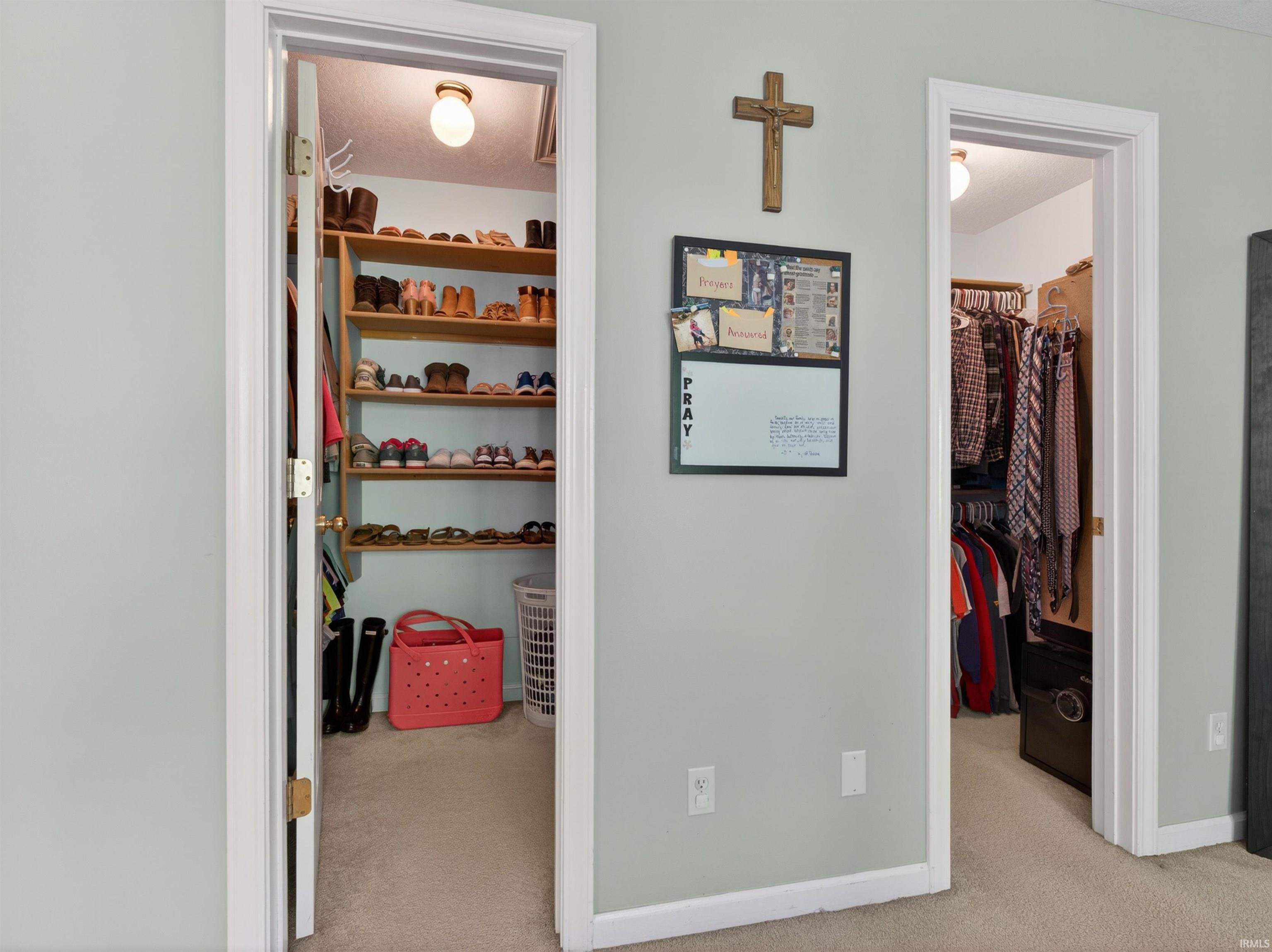Two separate closet entrances with light gray wall paint and white trim