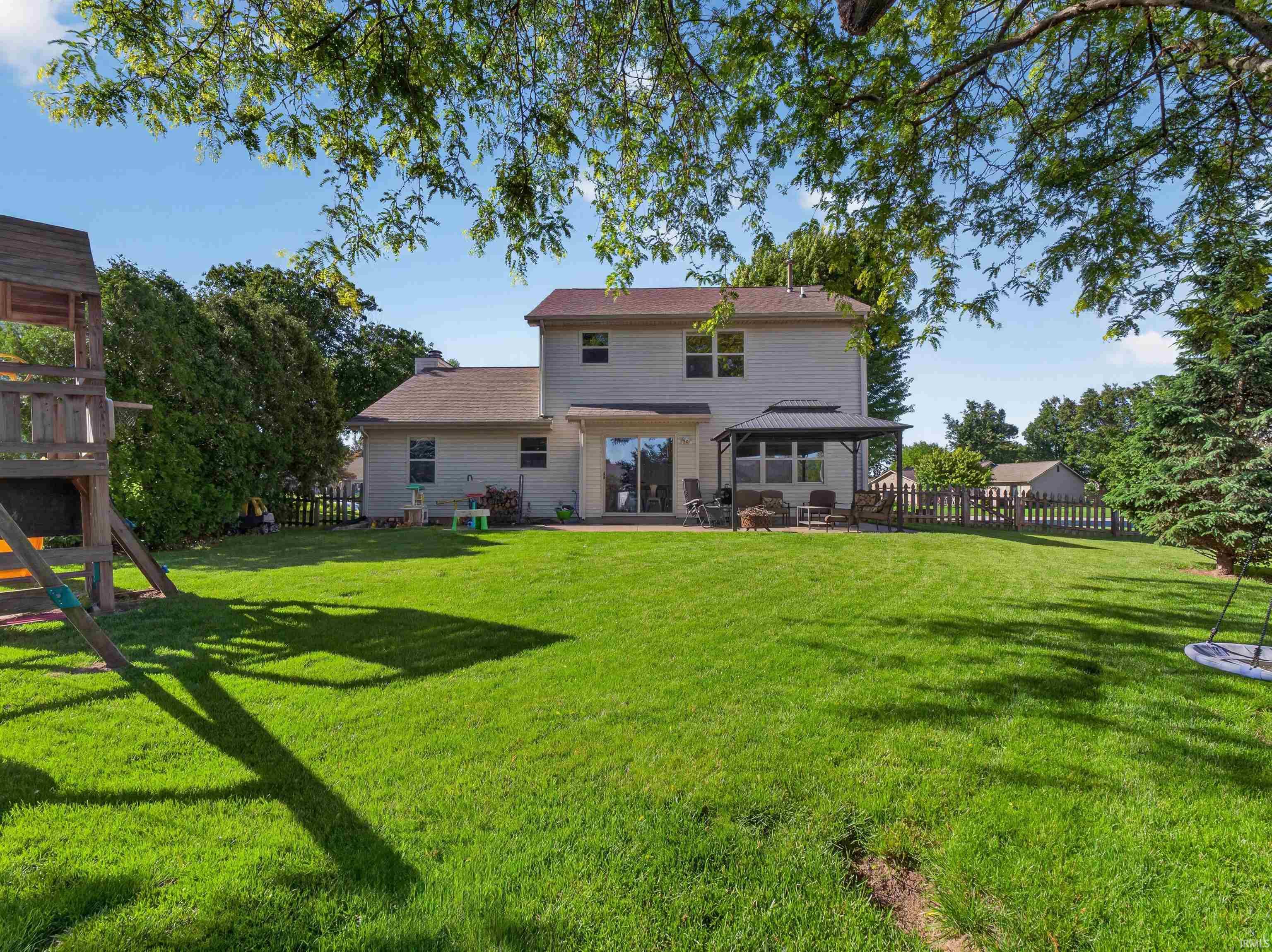 Expansive rear yard featuring a lush lawn and perimeter fencing