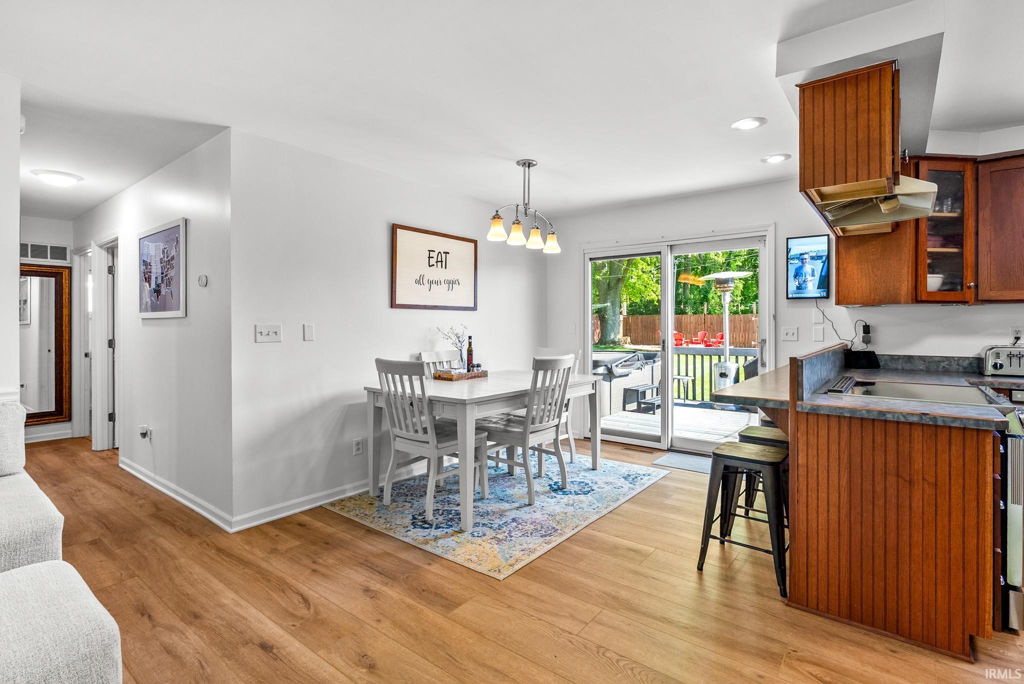 Open-concept kitchen and dining area with wood-finish flooring