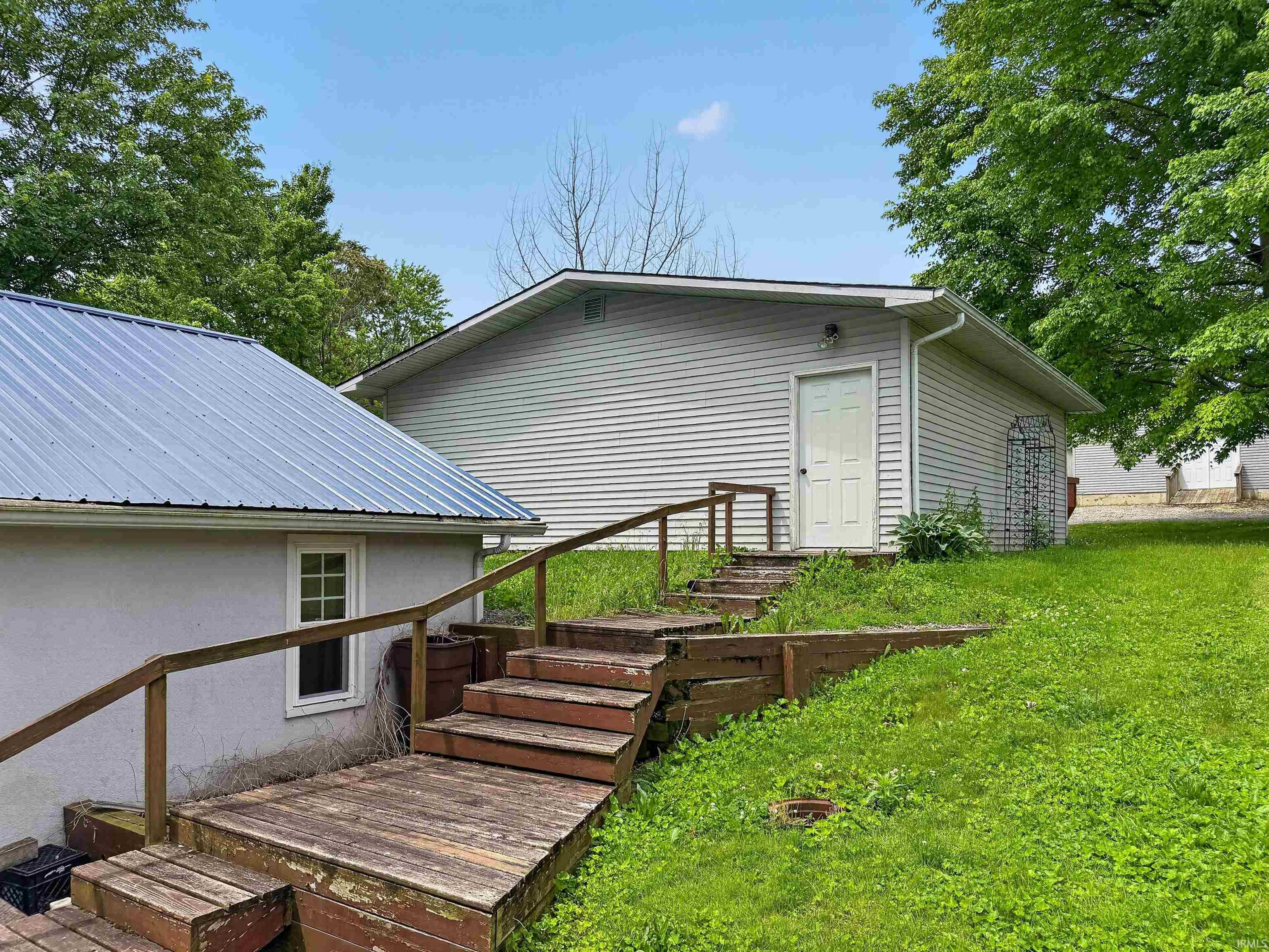 Exterior building featuring horizontal siding and a white entry door
