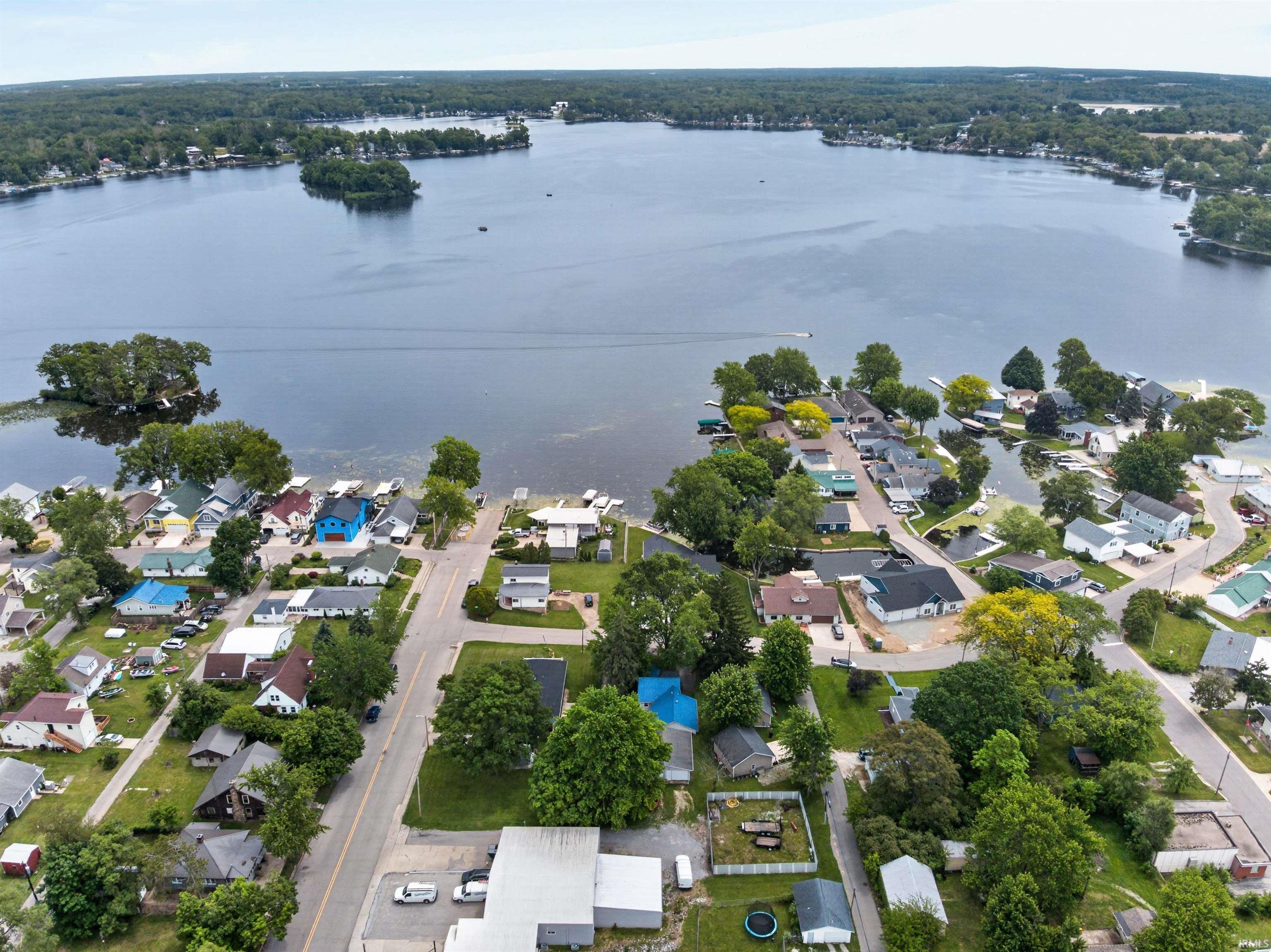 Aerial depiction of a lakefront community with numerous properties