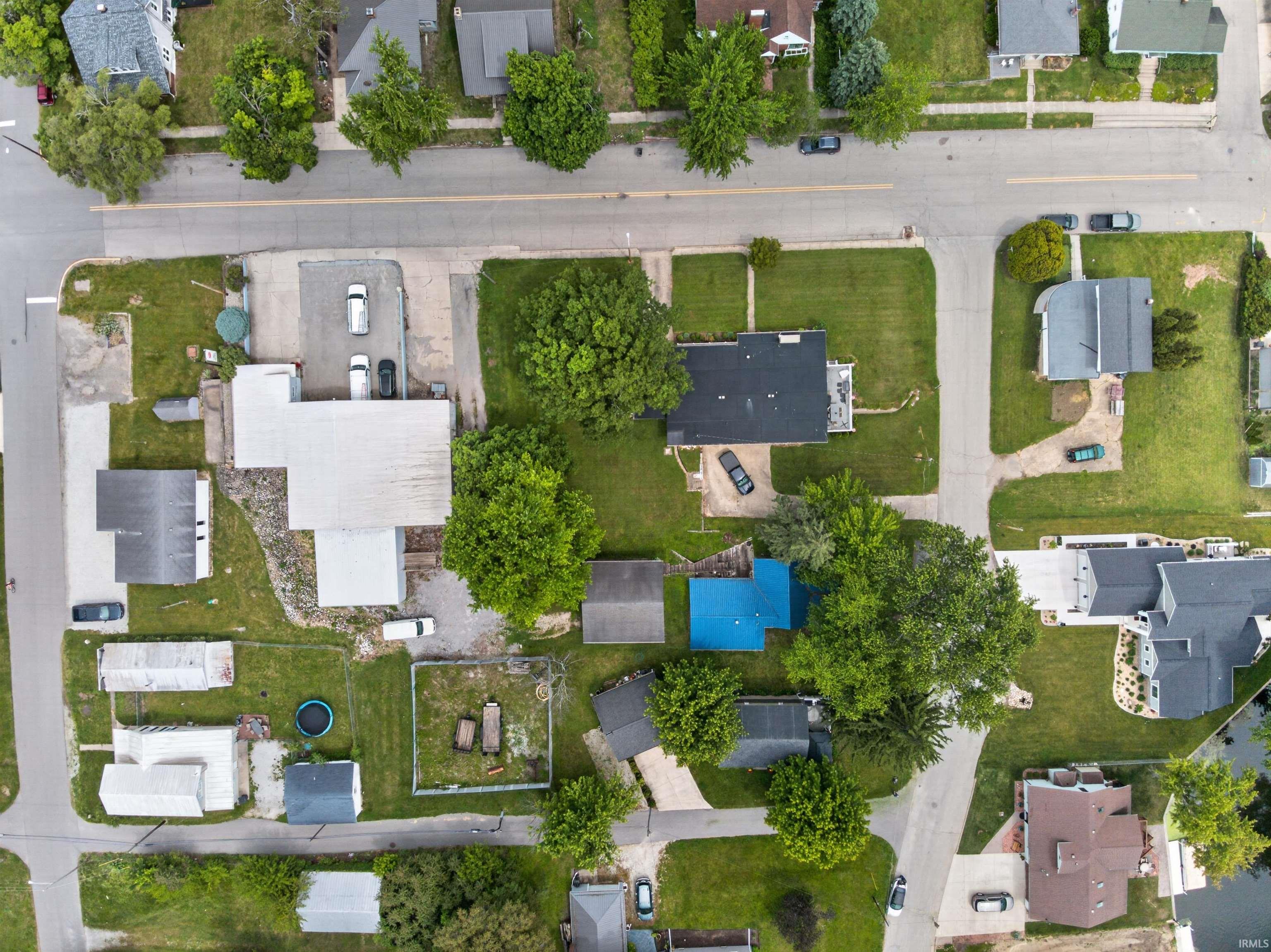 Aerial view showcasing multiple properties with diverse rooflines and varying lot sizes